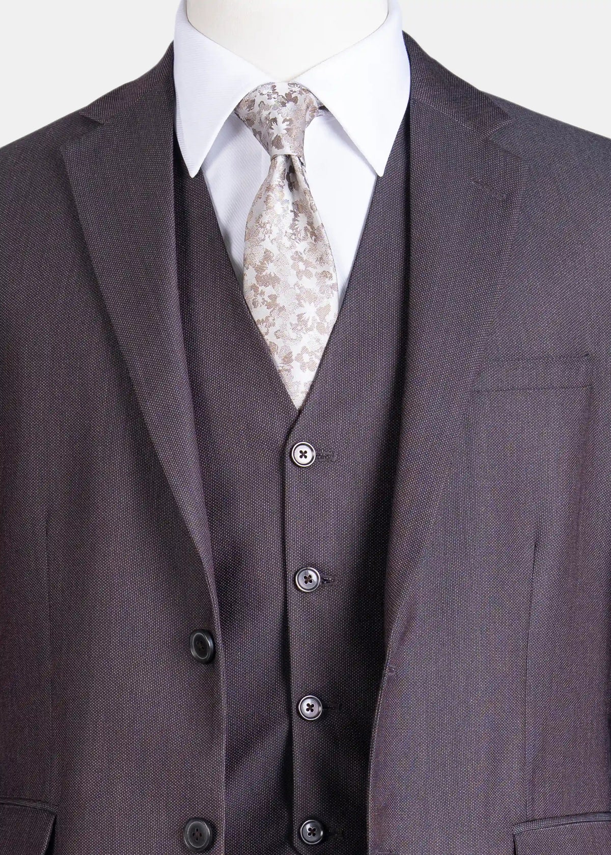 Dark brown suit vest with covered buttons and patterned tie under notch lapel