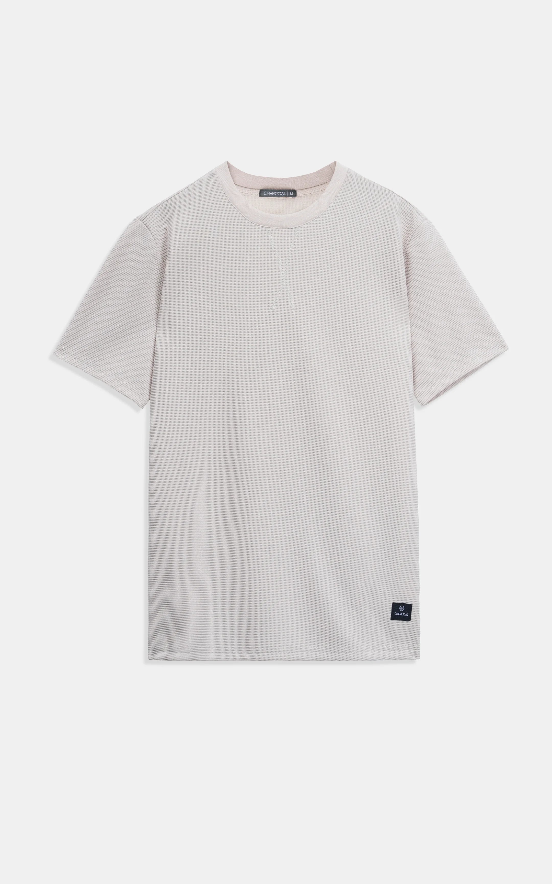 Beige crew neck T-shirt with short sleeves and small square logo patch