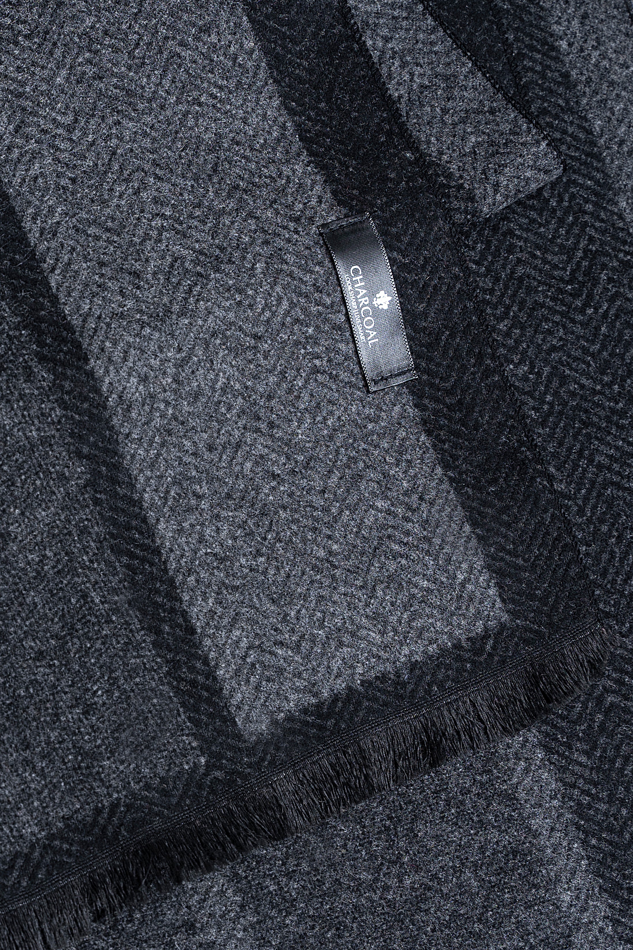 Dark blue and gray plaid scarf with brand label tag and fringed trim