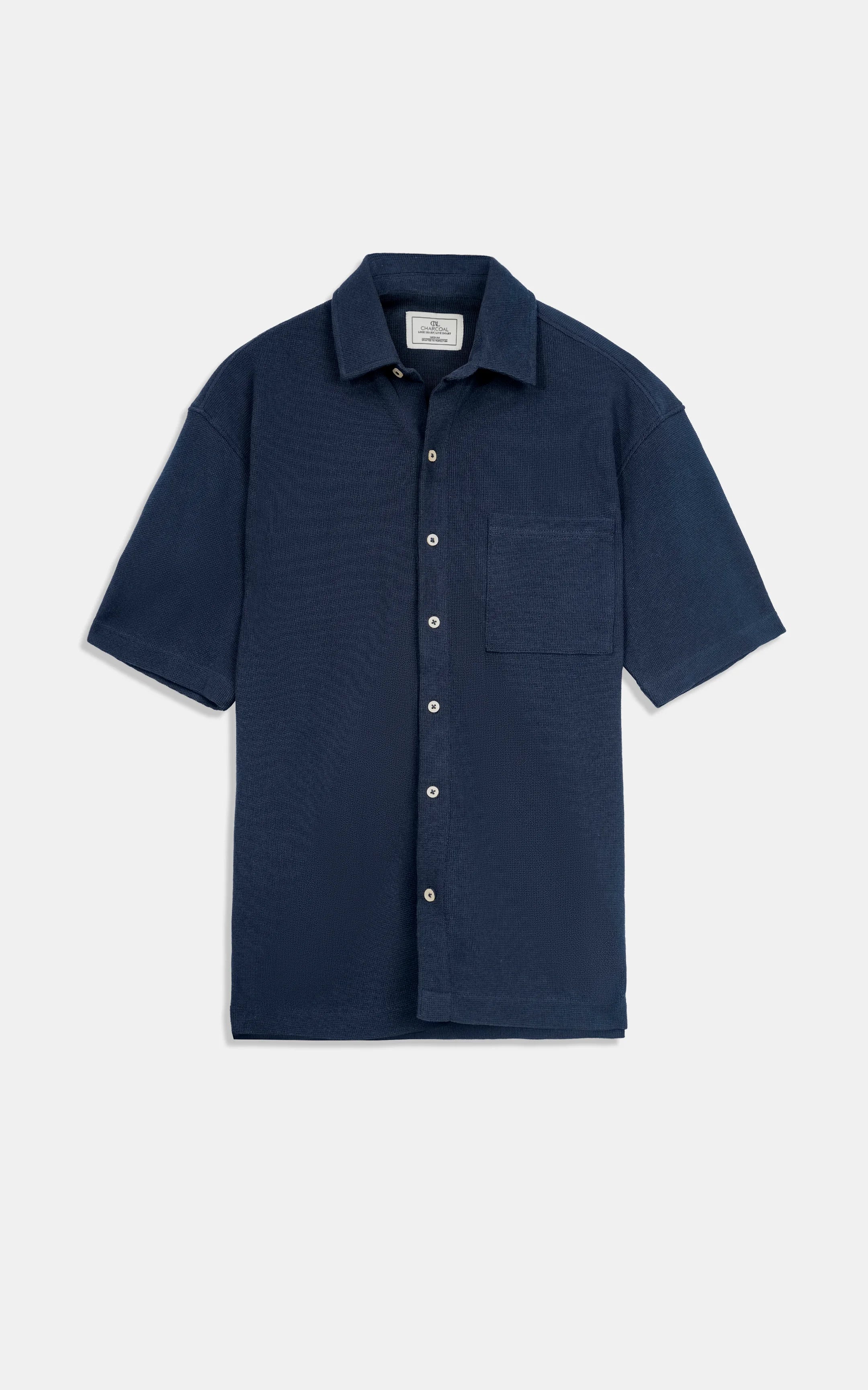Navy short-sleeve knit button-up shirt with chest pocket, flat lay.
