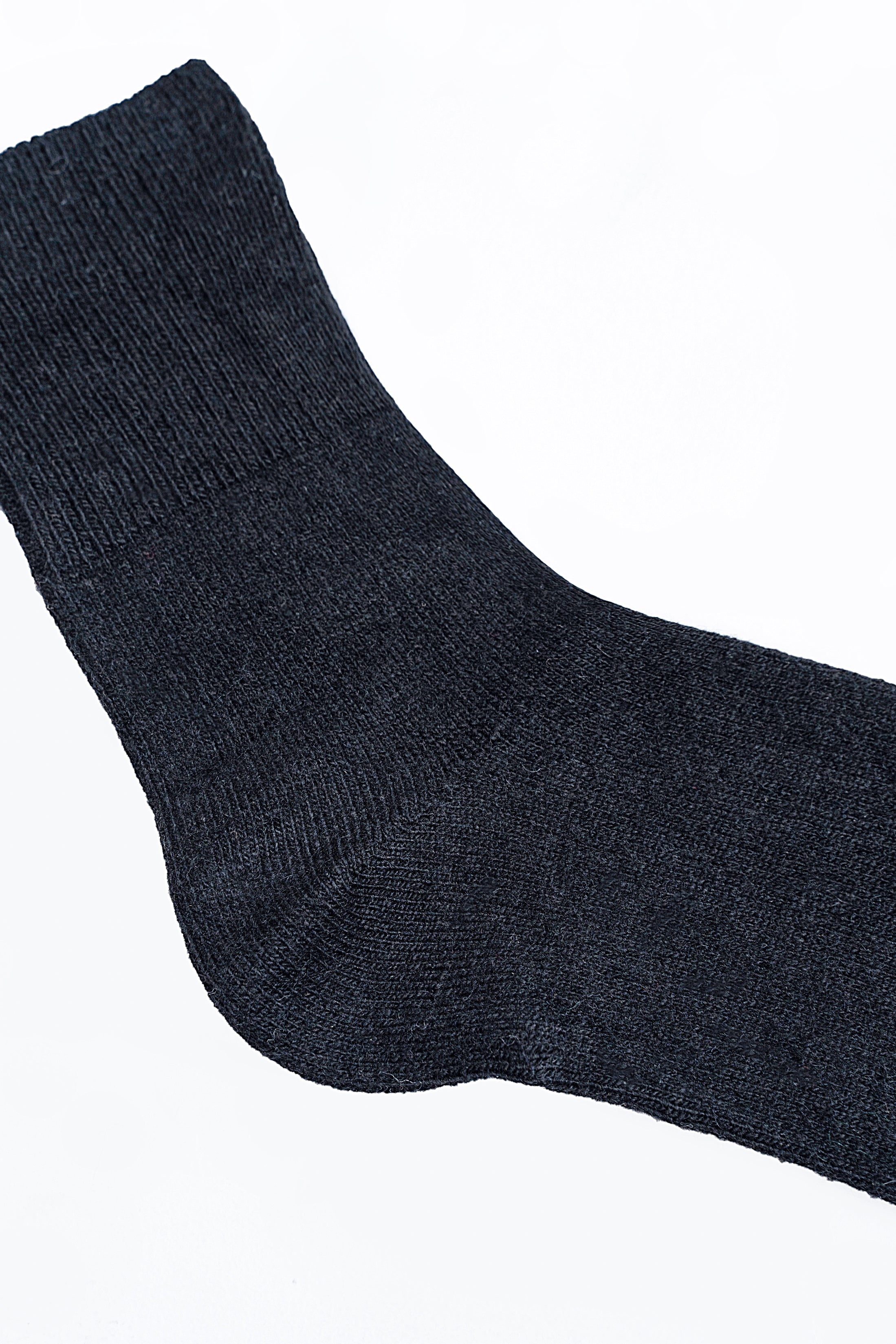 Dark blue wool sock close-up showing knit texture and ribbed cuff