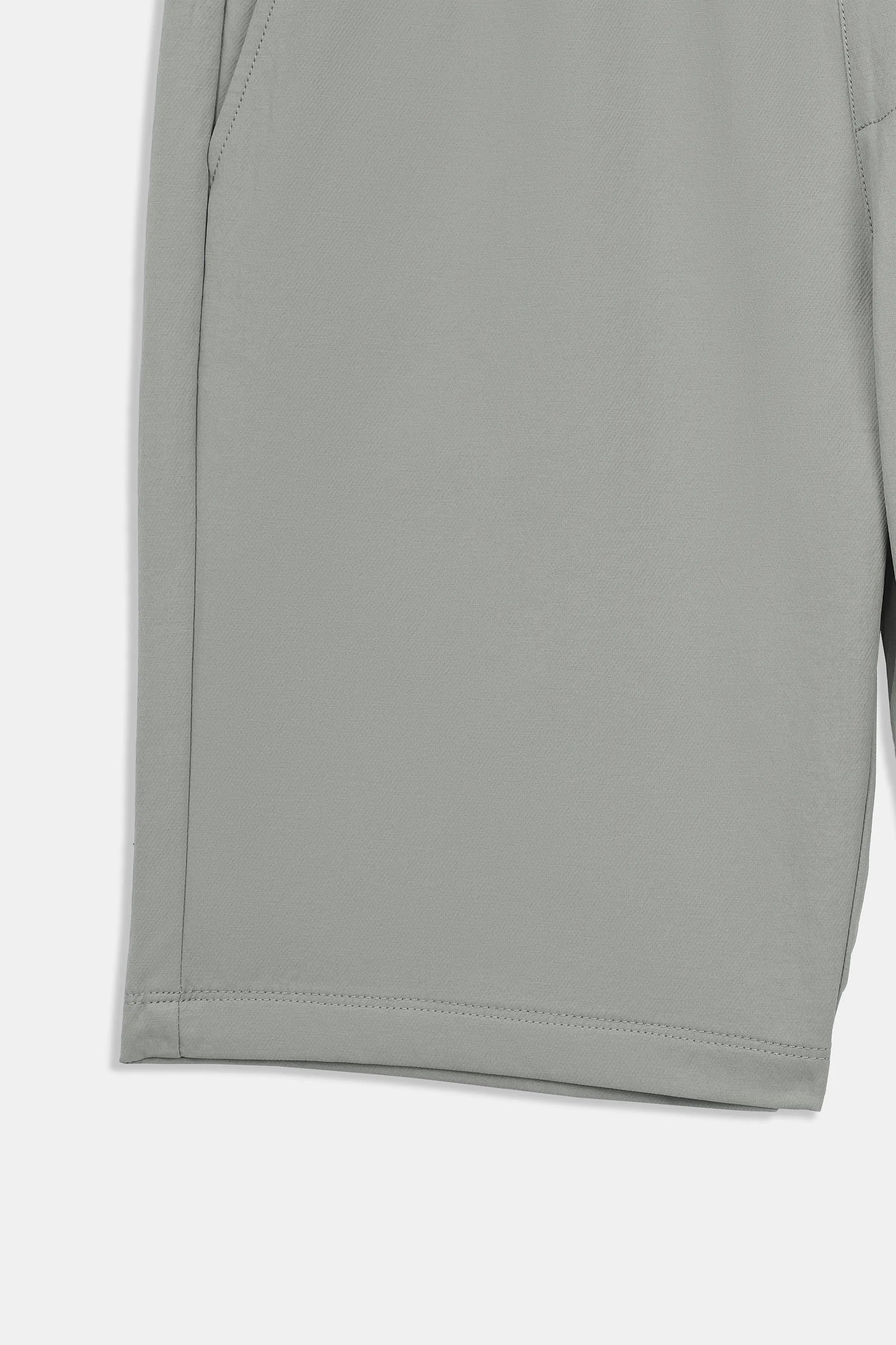 Olive shorts with clean front seam and hem with visible stitching.