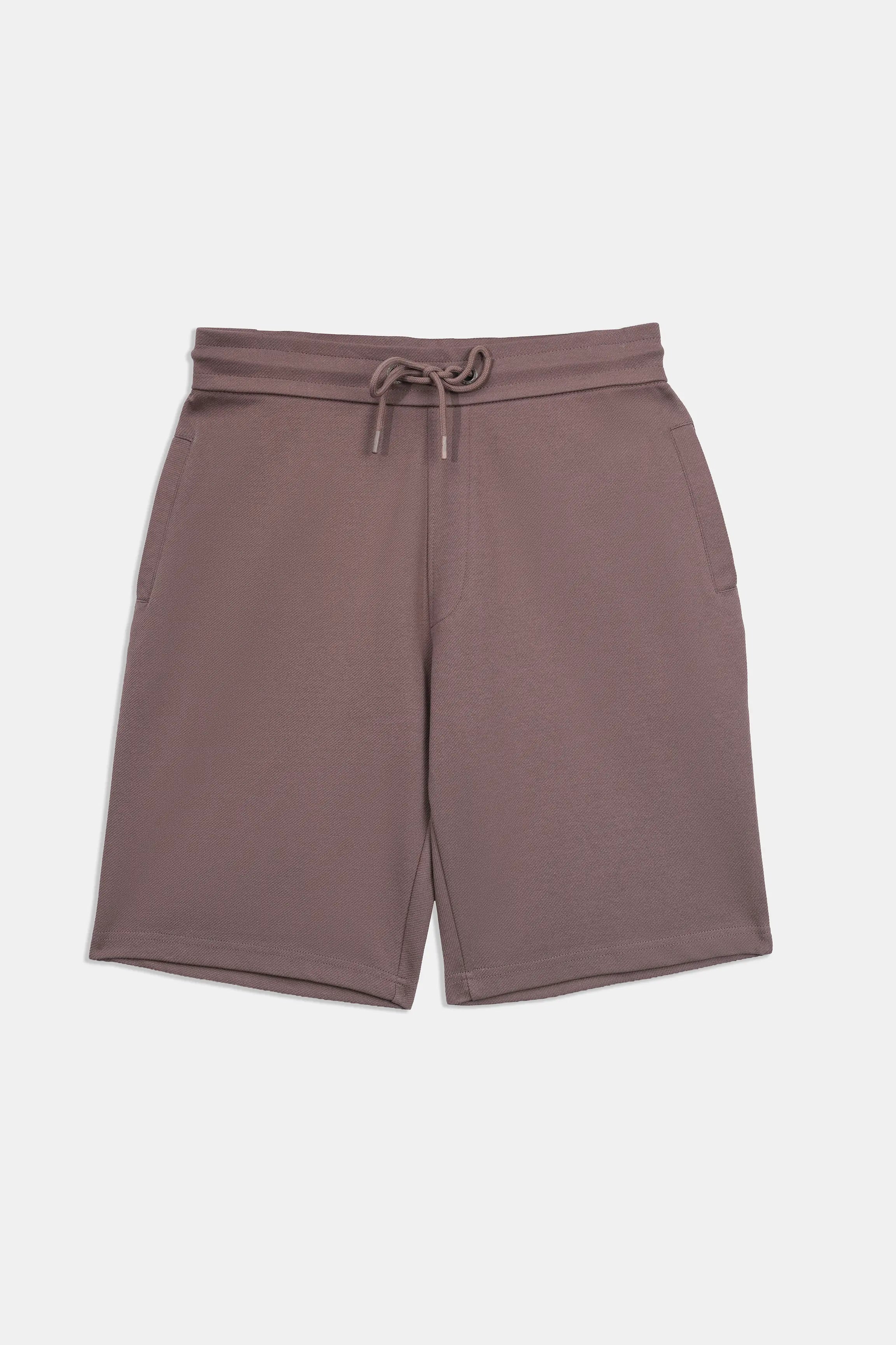 Rust-brown elastic-waist drawstring shorts, flat front with mid-thigh length.