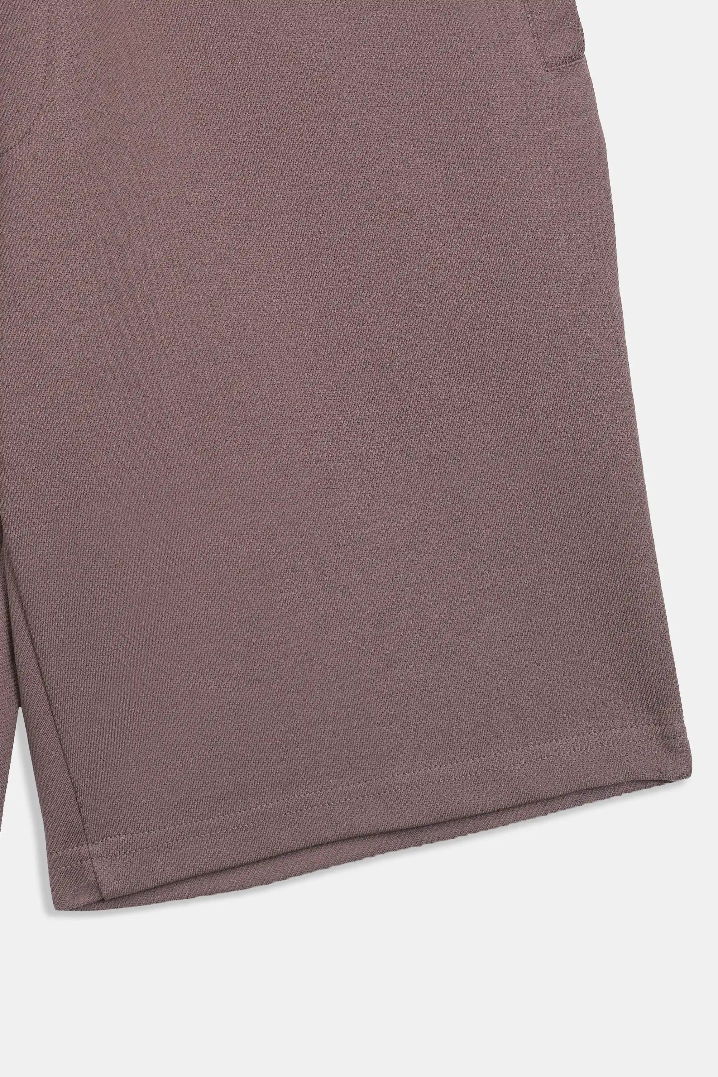 Rust-brown fabric shorts with straight hem and relaxed side drape.