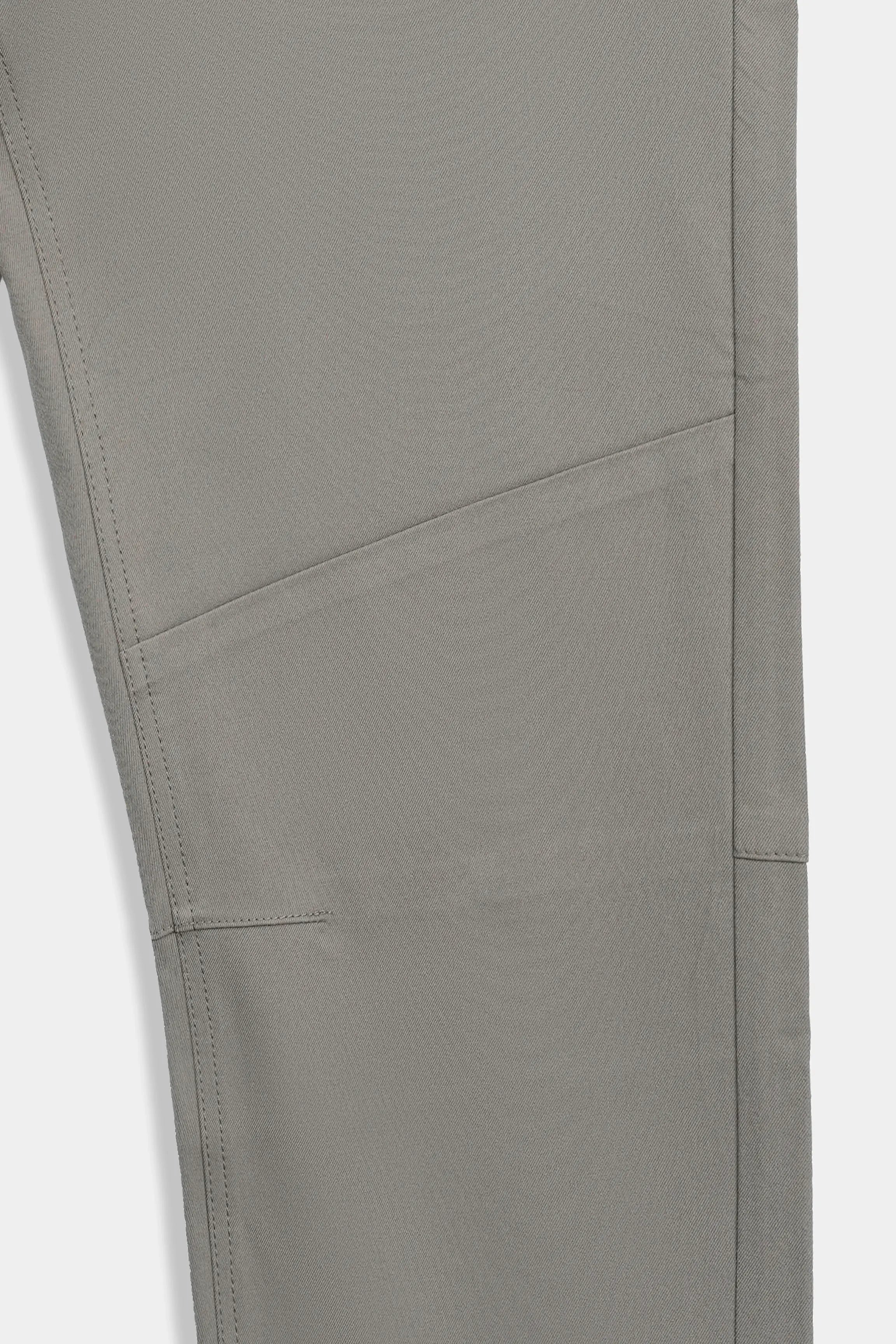 Straight-fit travel pants in light brown, close view of leg seam and stitch lines.