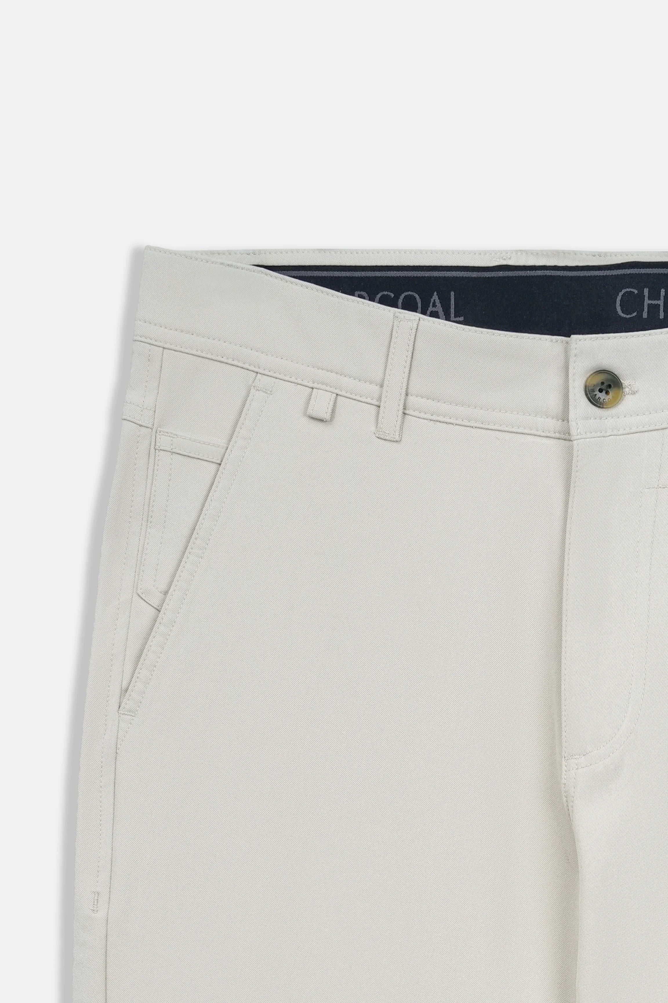 Light beige waist with belt loops and button fly; inner label at waistband