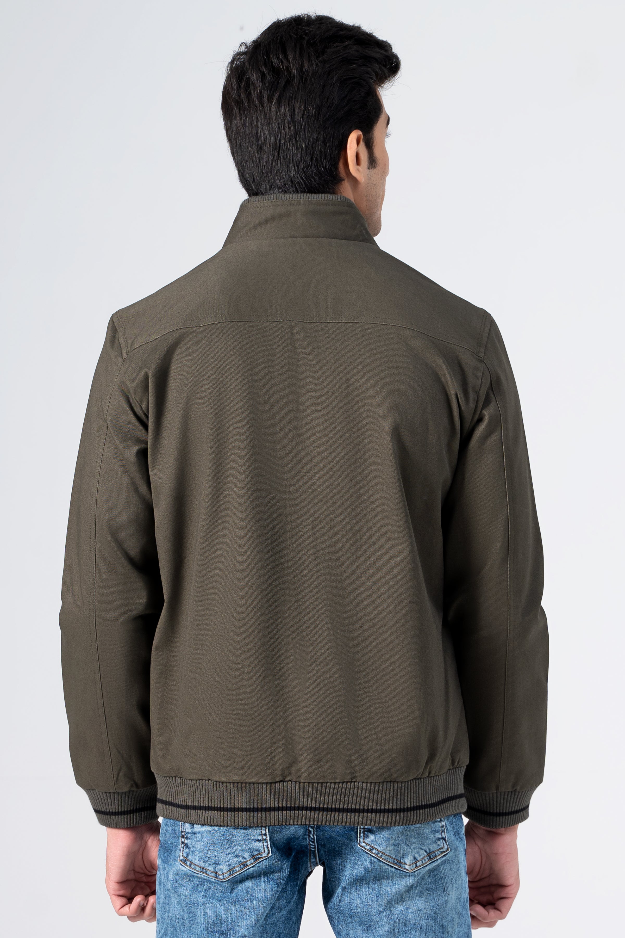 Reversible jacket in olive, back view, stand collar and full zip with ribbed cuffs