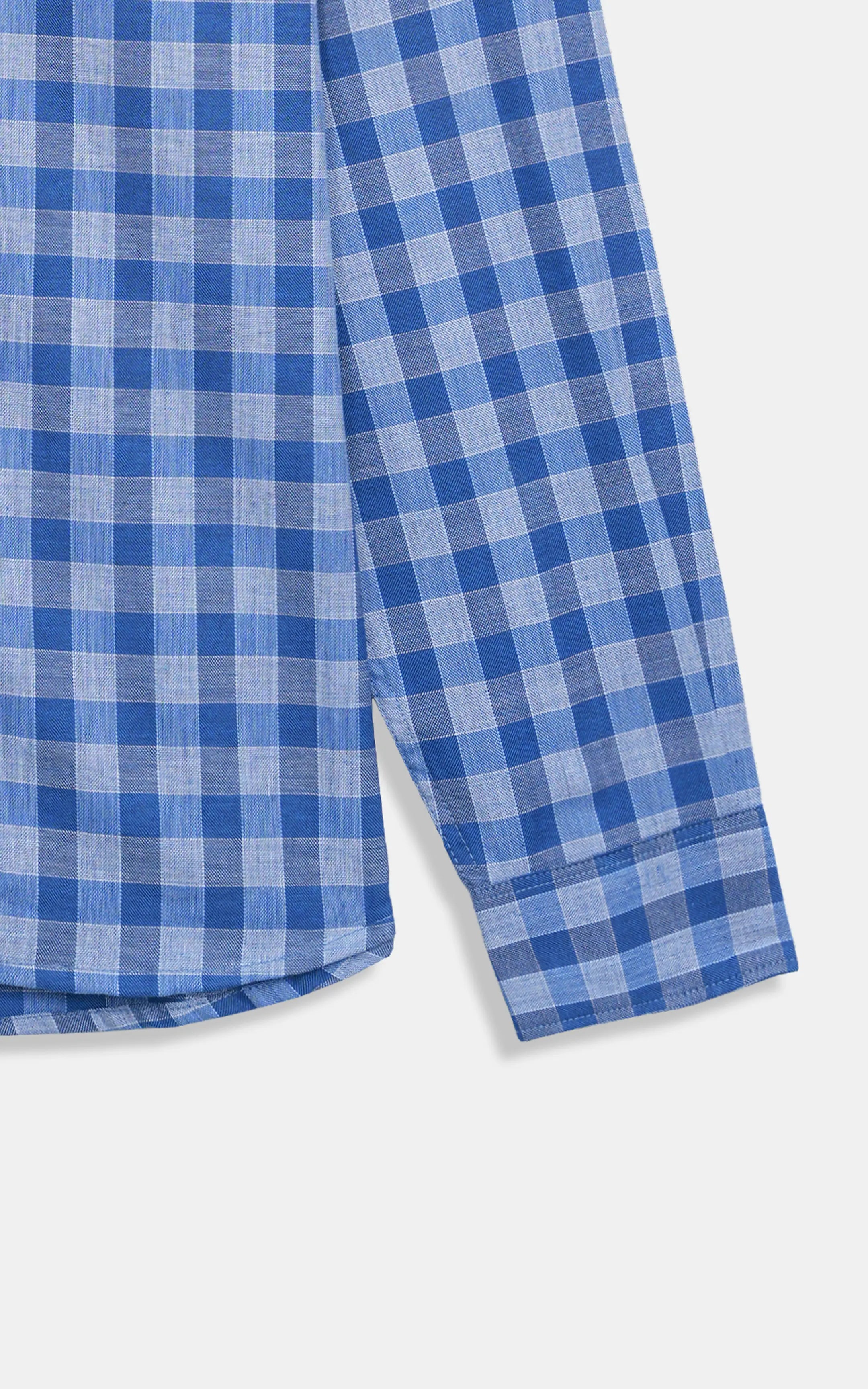 Blue and white checkered button-down shirt hem and side seam close-up