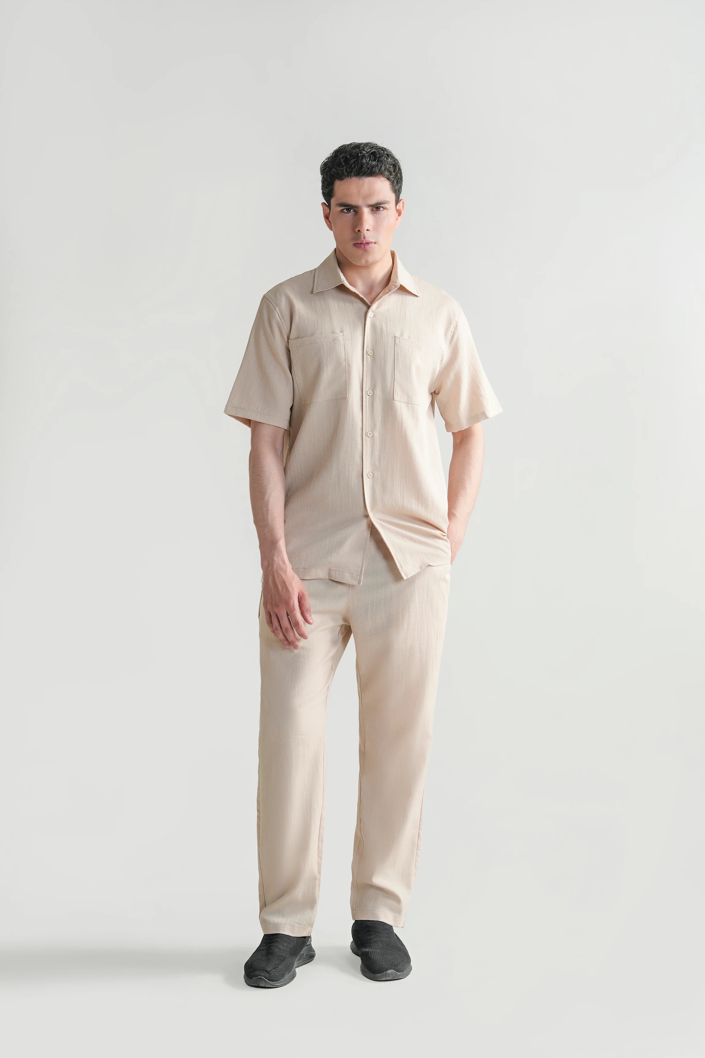 Beige short-sleeve casual shirt with regular collar, button-front, and chest pockets