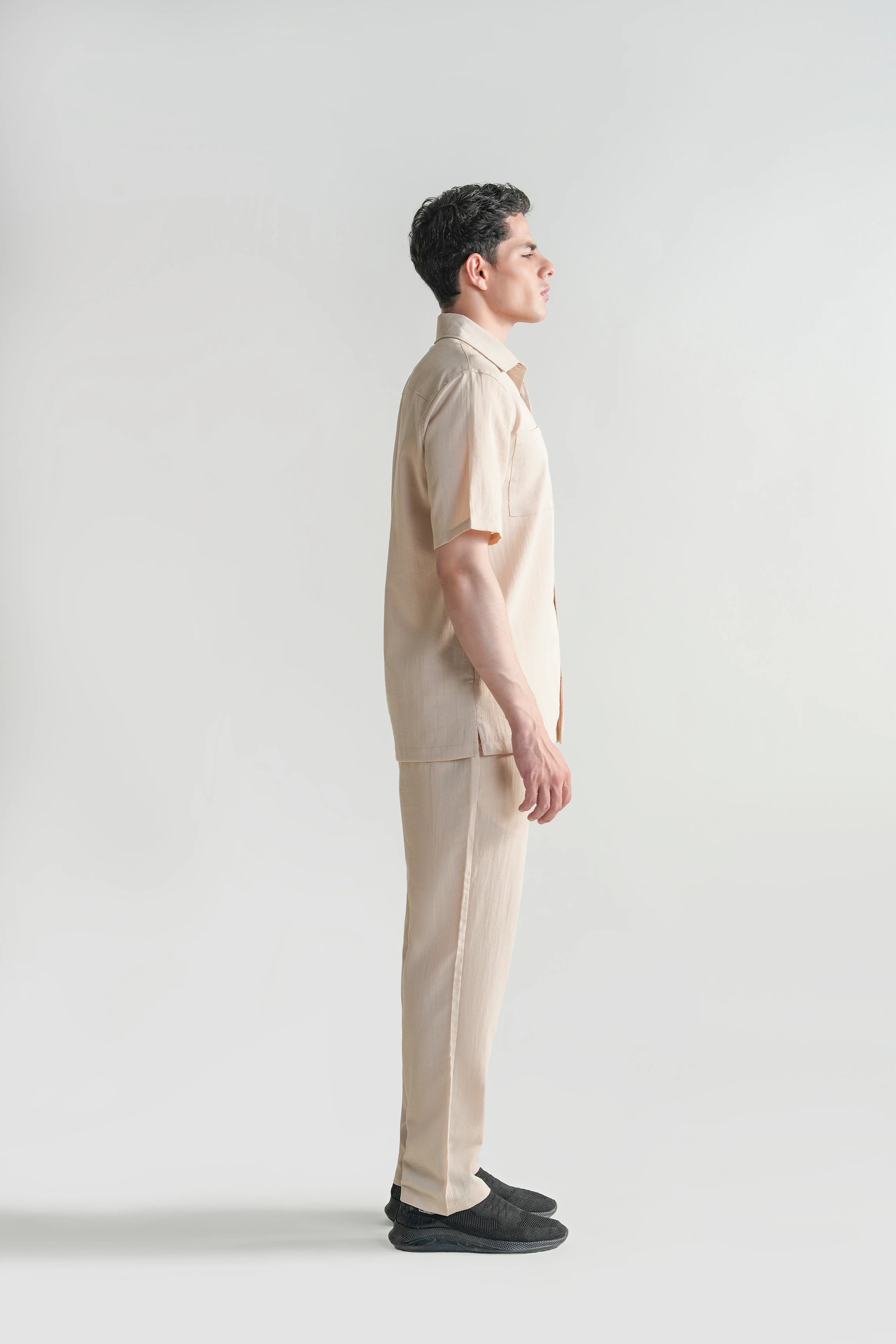 Beige casual button-up shirt with short sleeves and regular collar, side view