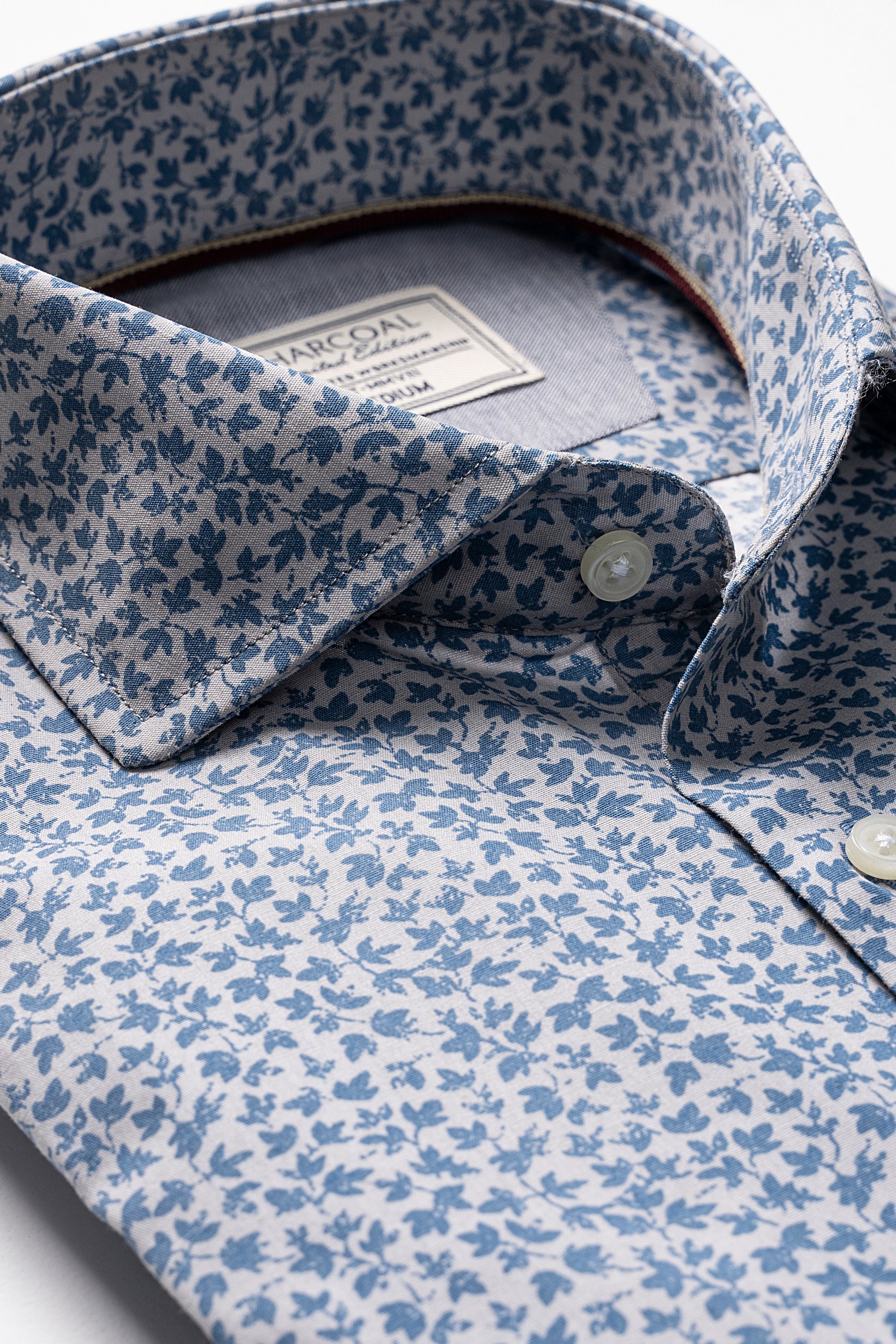 Light blue floral dress shirt with point collar and button placket, visible label