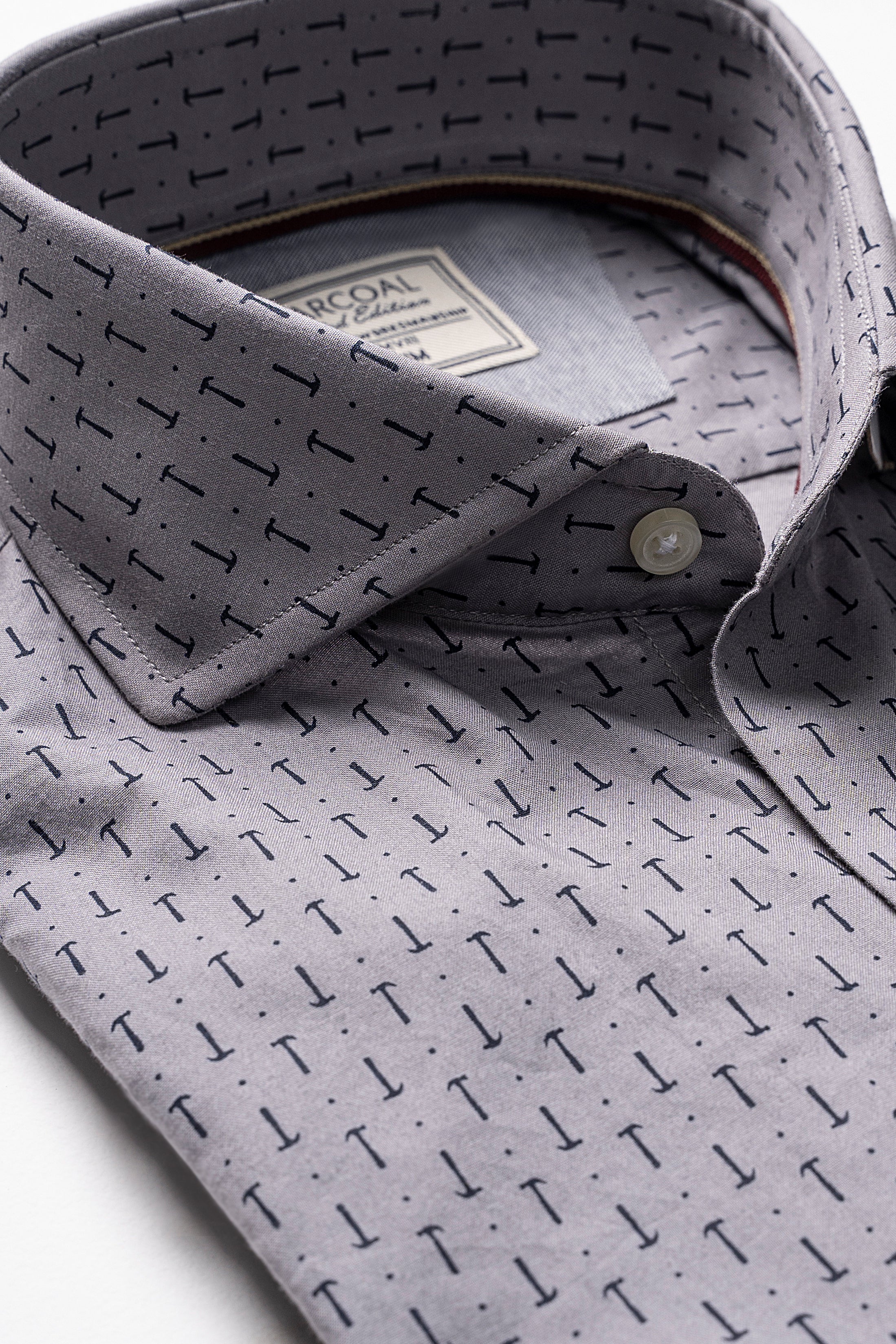 Light grey button-up shirt with dark geometric pattern and button-down collar