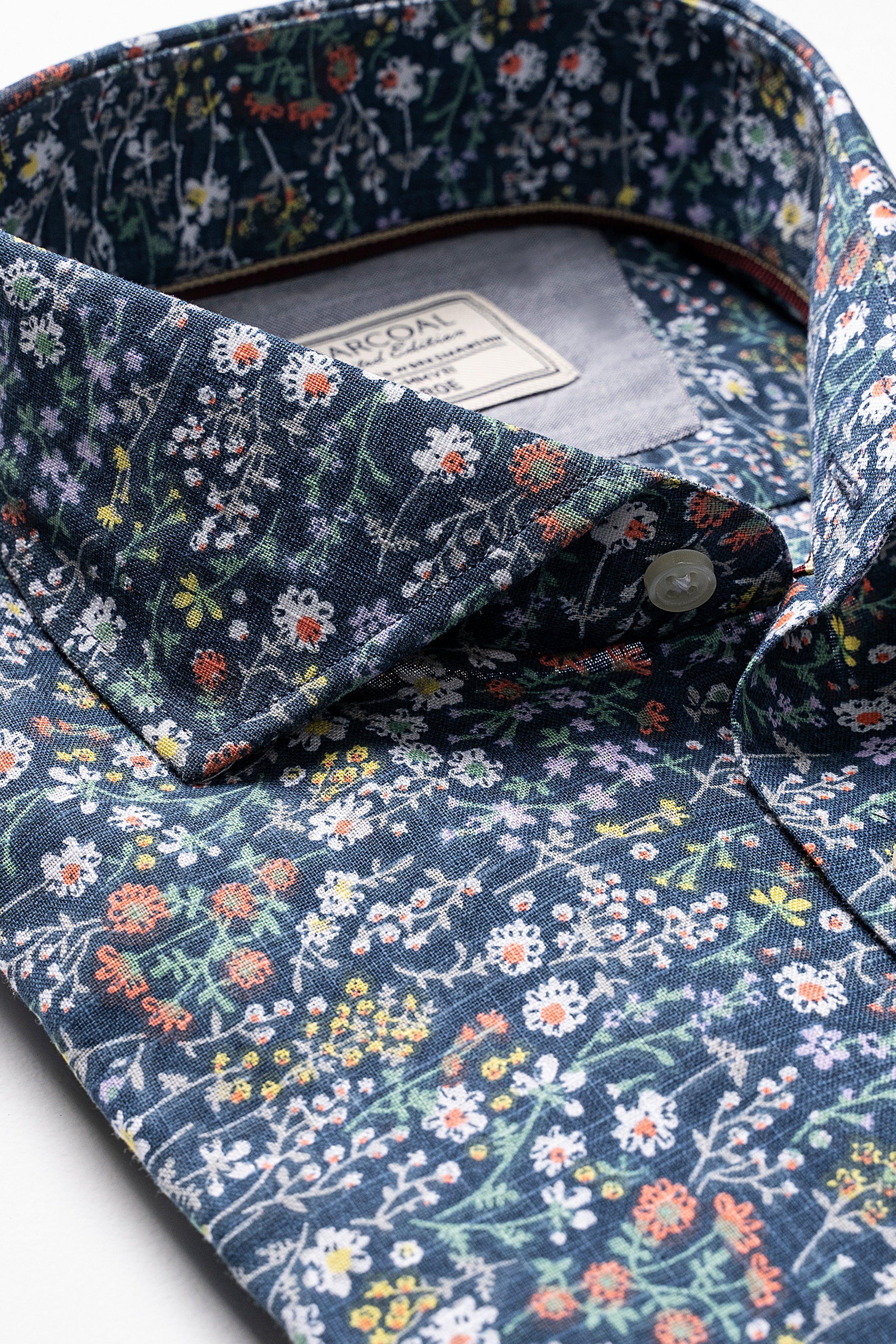 Forest green floral button-front shirt with open spread collar and inner tag