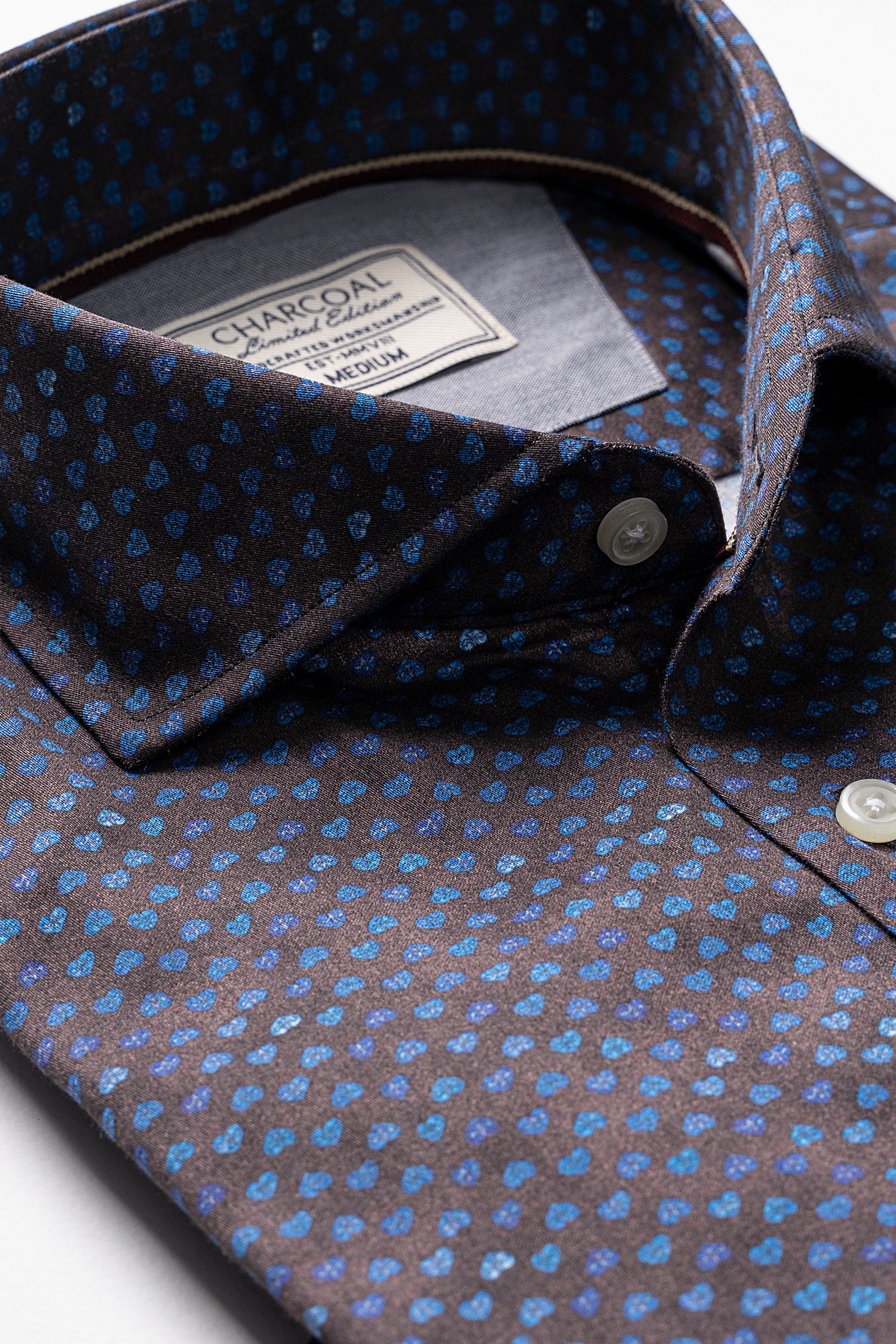 Dark brown button-up shirt with blue dot pattern and collar