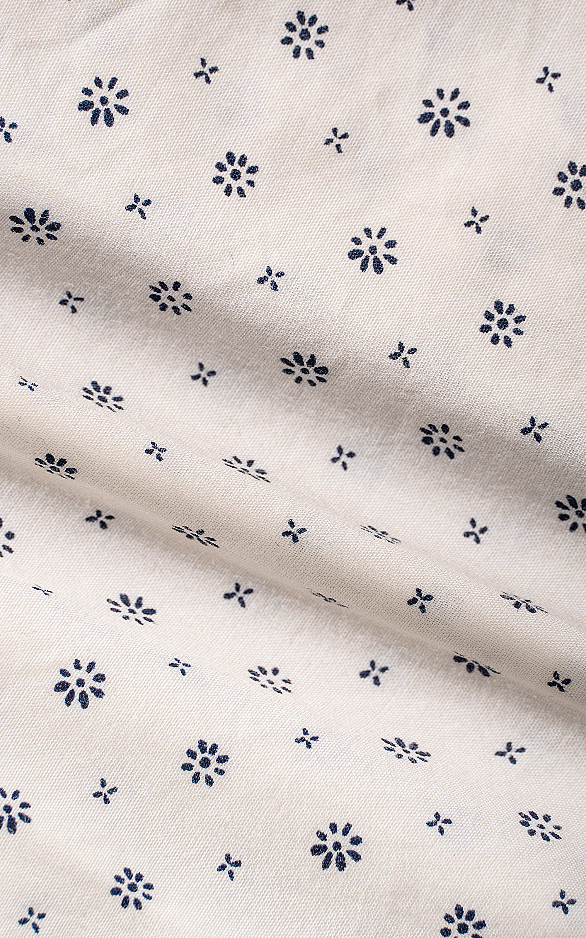 White dress shirt fabric with repeating navy floral dot micro pattern