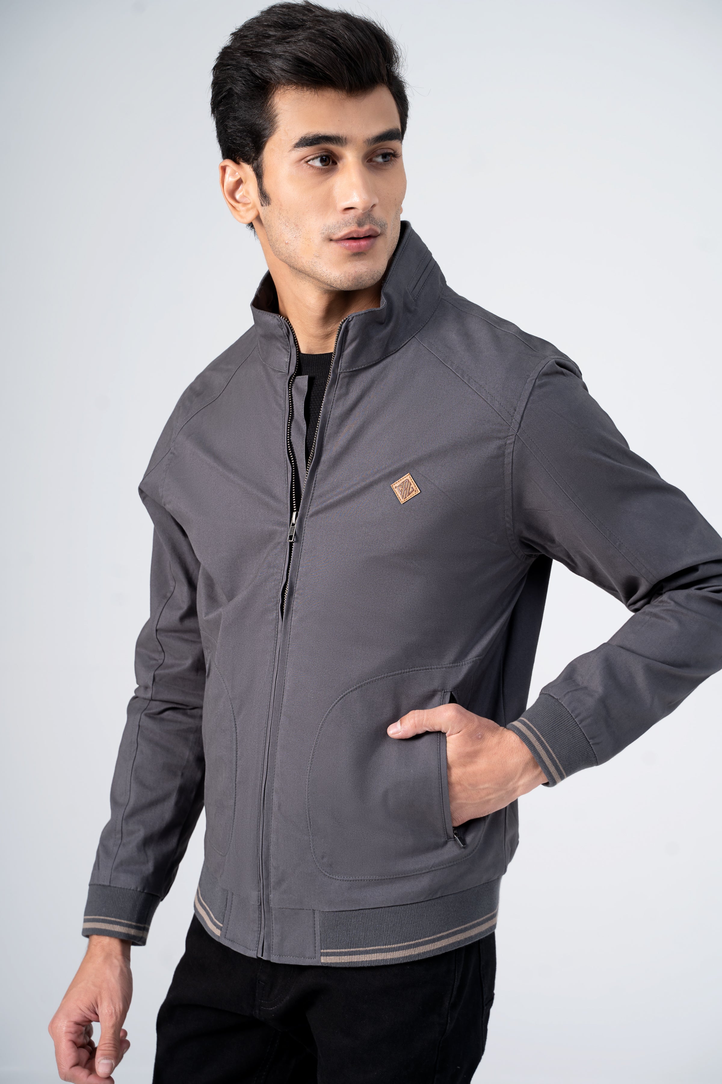 Grey cotton zip jacket with stand collar, chest logo patch and ribbed cuffs