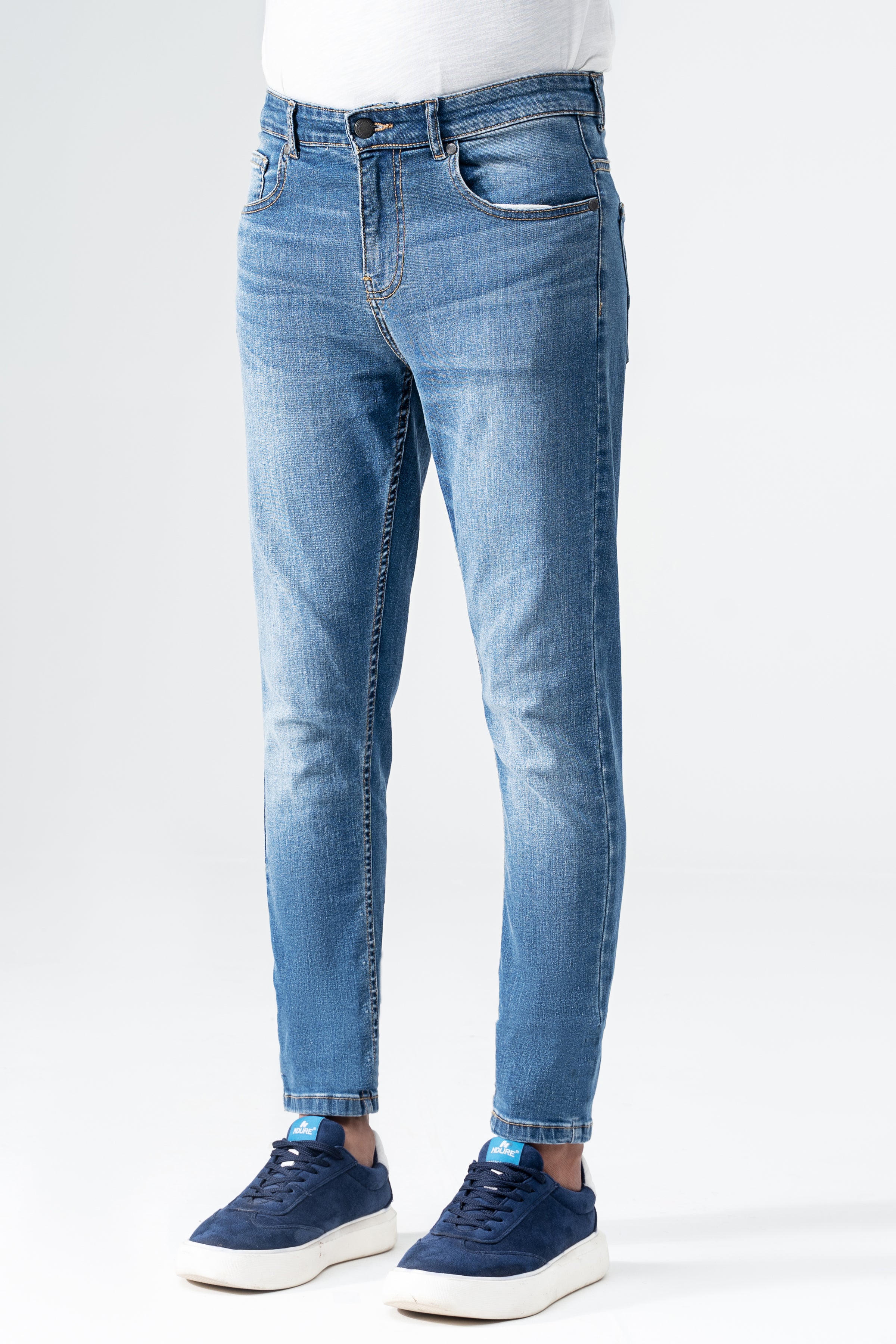Mid-blue skinny denim jeans with front fly, belt loops, and subtle knee whiskering