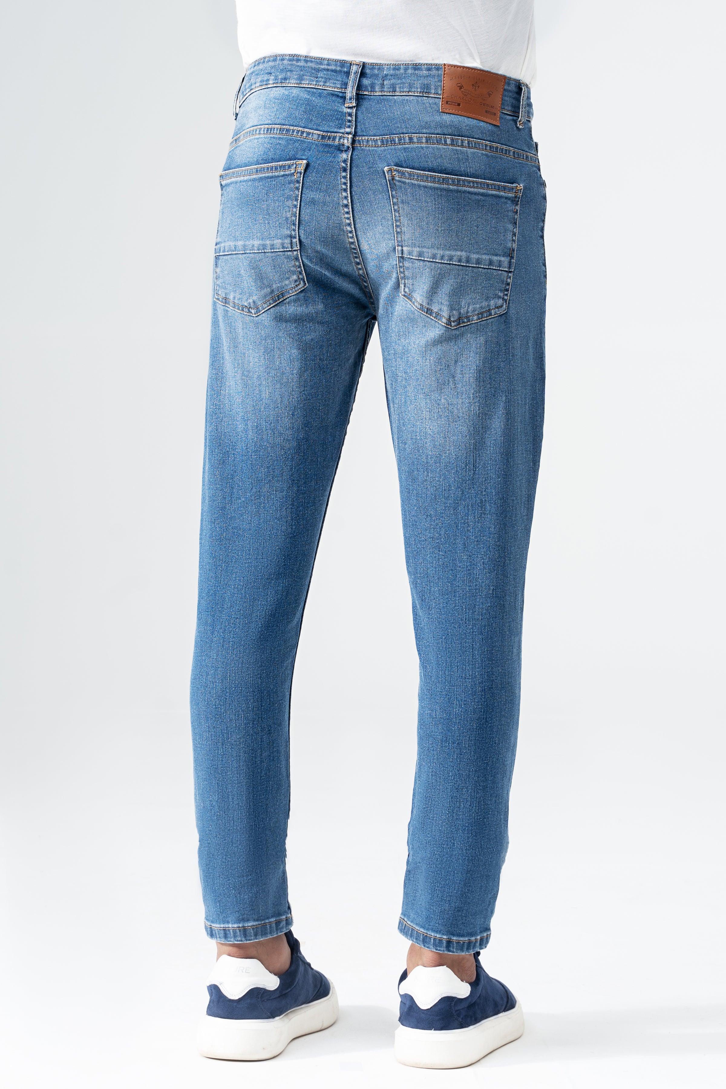 Mid-blue skinny denim jeans with back yoke, rear patch pockets, and belt loops