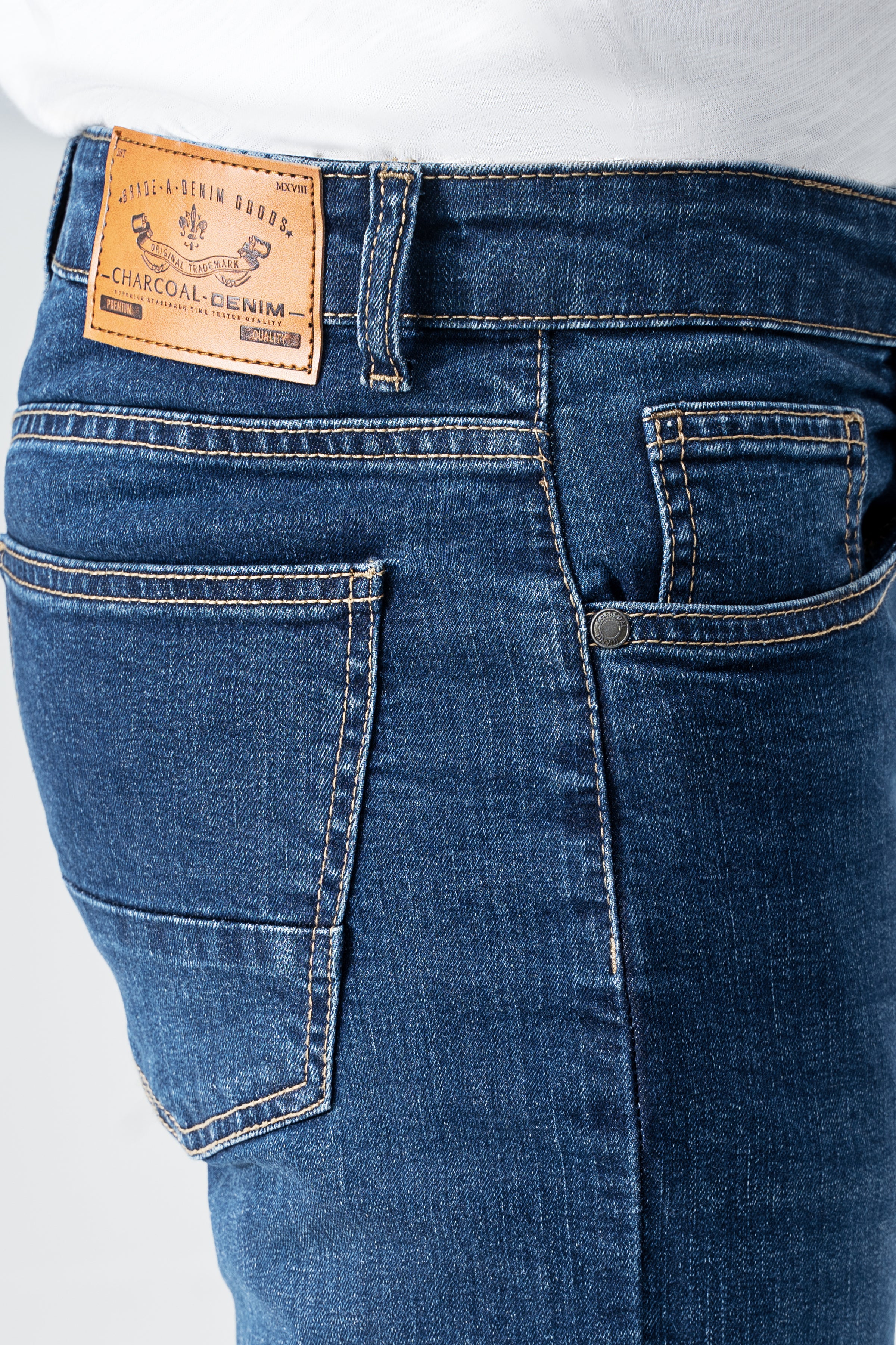 Dark blue denim jeans close-up of waistband label and front pocket
