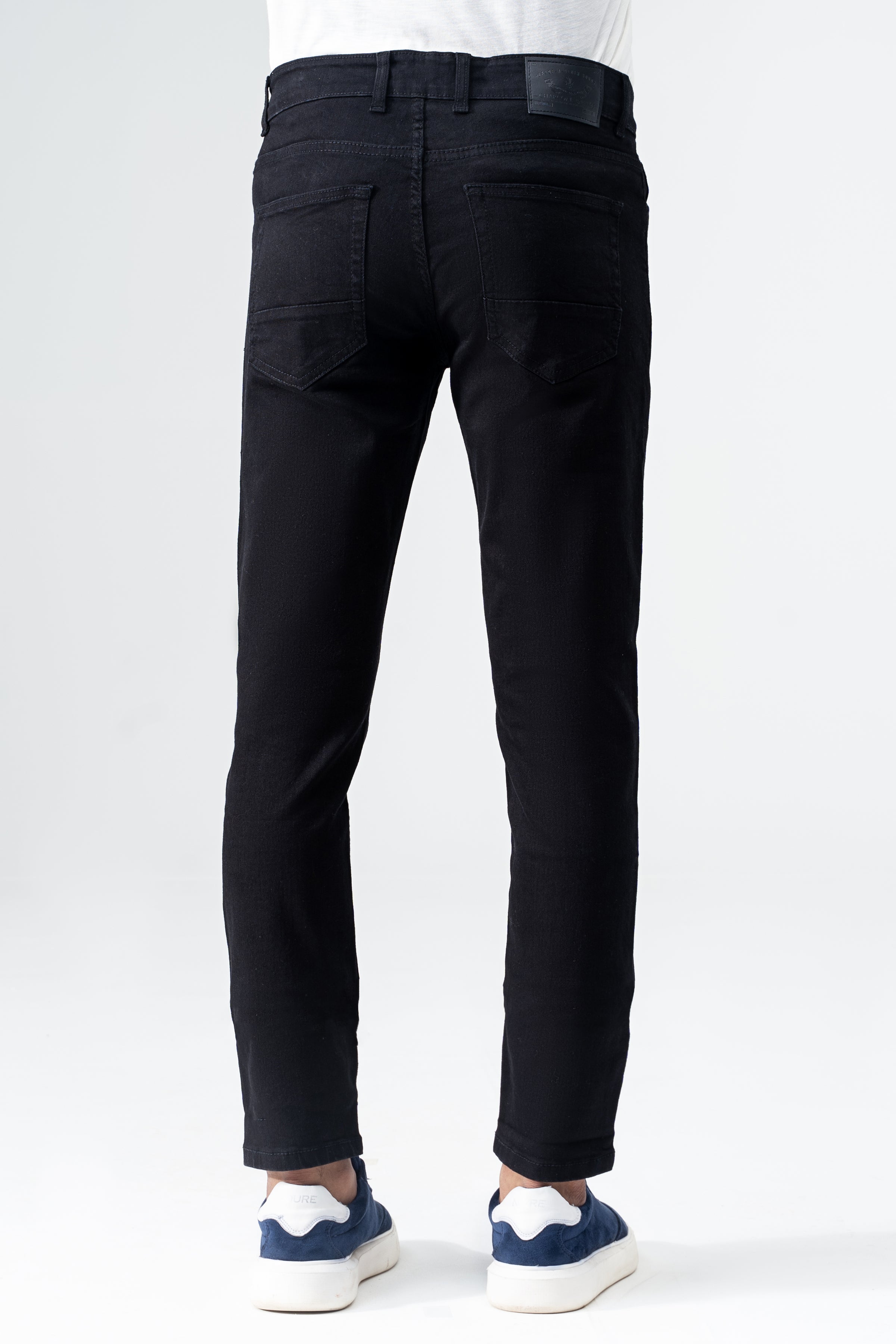 Black slim-leg denim jeans back view with rear pockets and belt loops