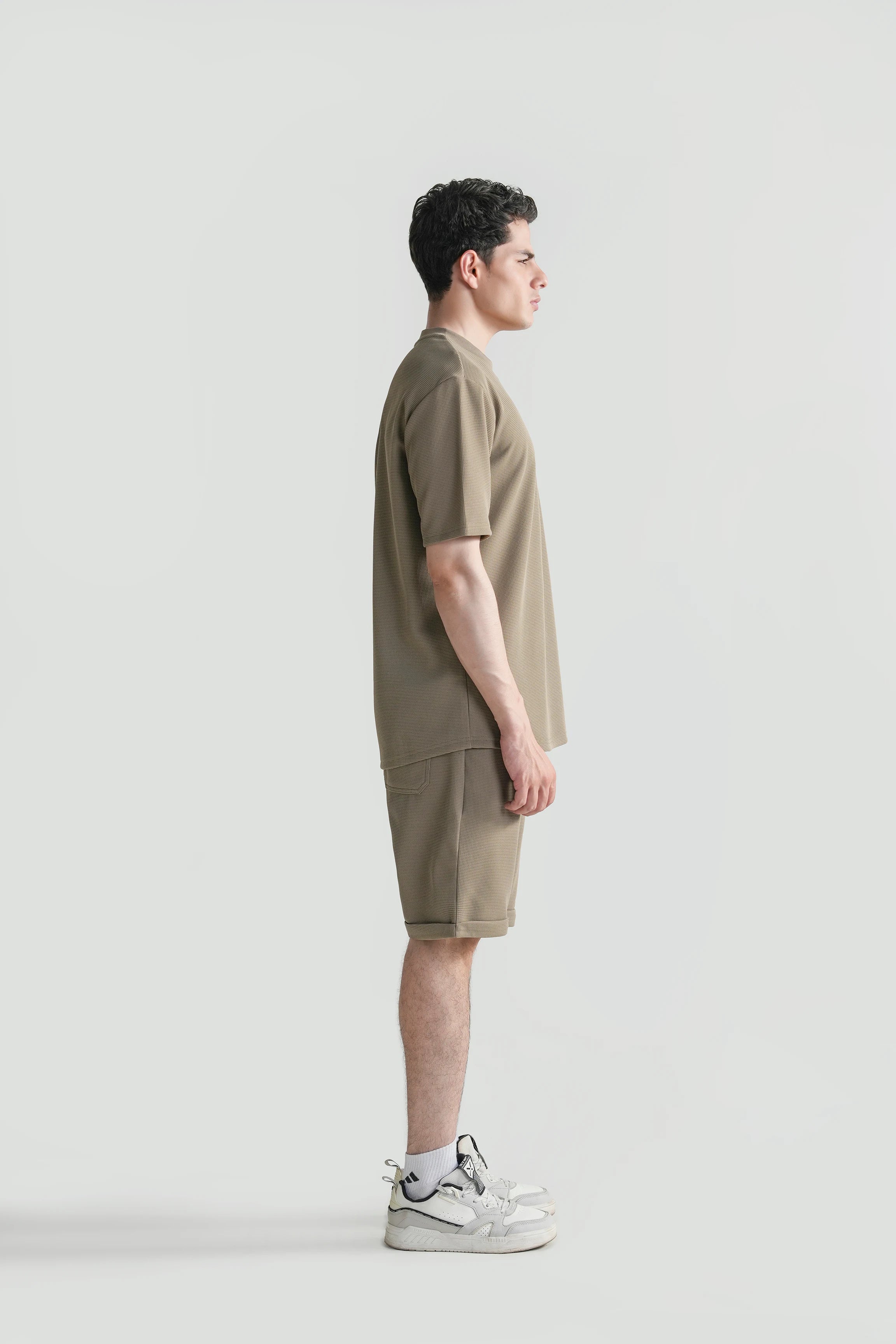 Oversized crew neck T-shirt in muted green, side view with short sleeves and hem