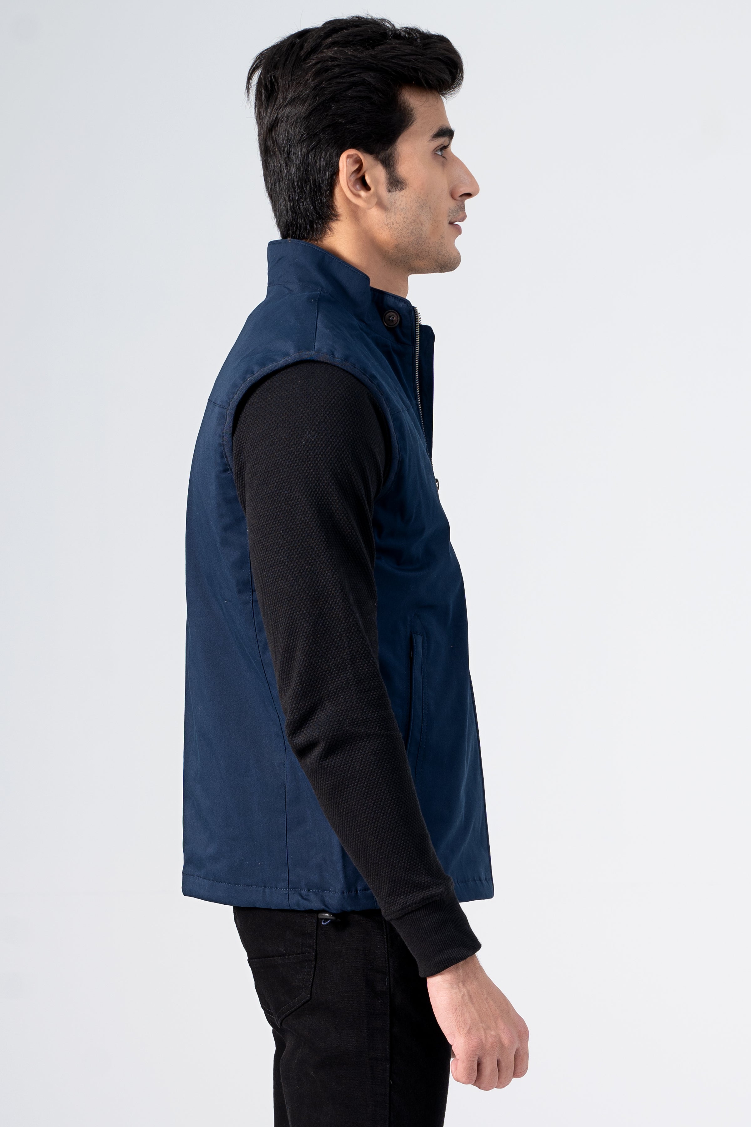 Navy wadded cotton jacket with full-zip front, worn over black long sleeves