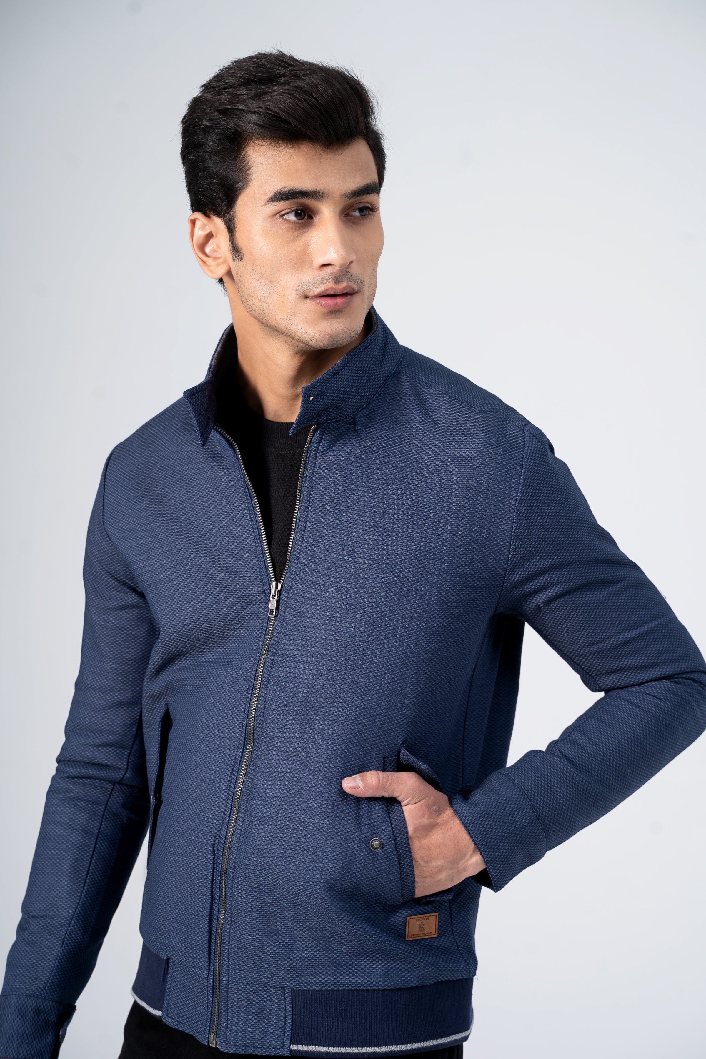 Navy textured zip-up jacket with stand collar, contrast cuffs, front detail