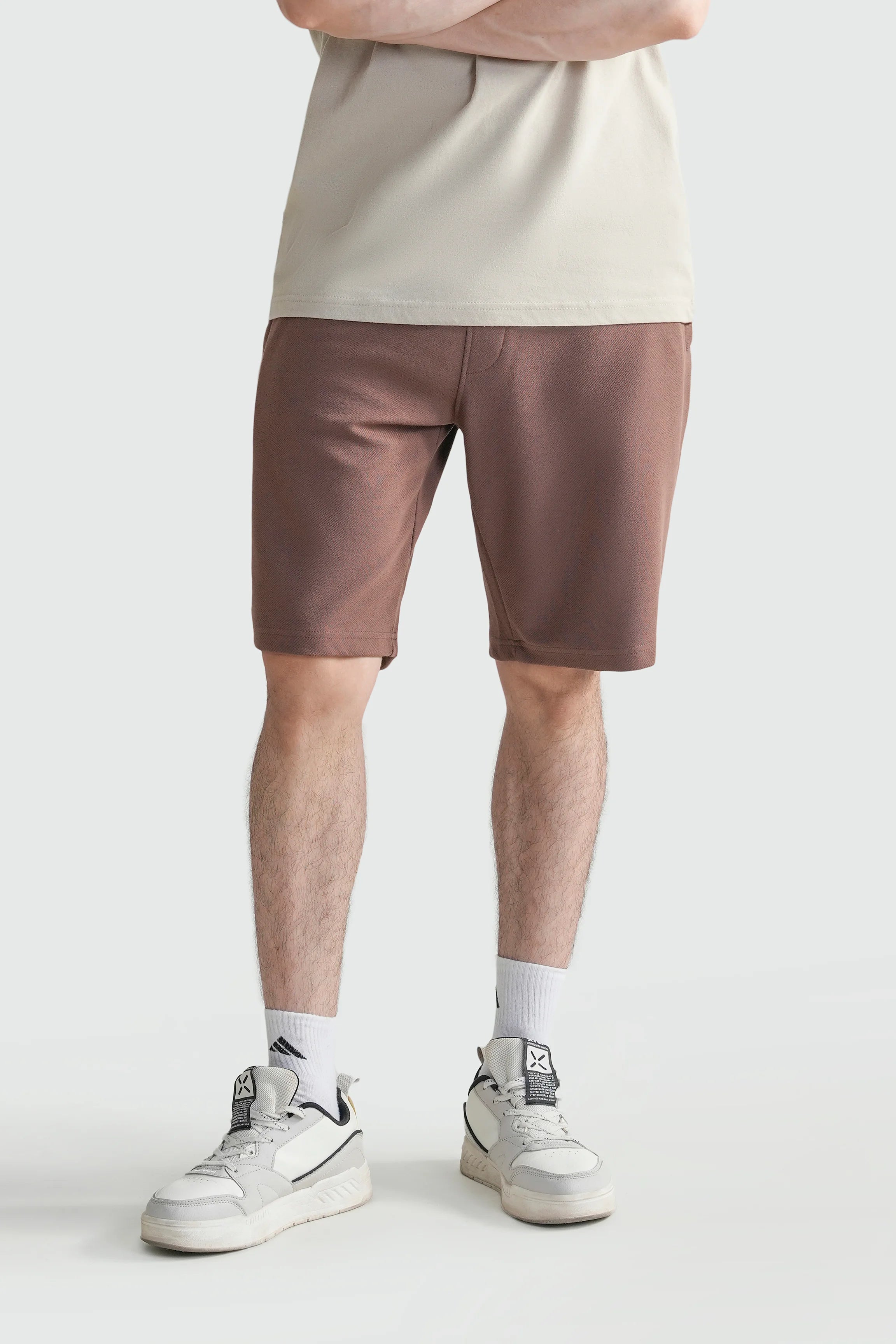 Men's regular-fit rust-brown shorts with elastic waistband, front view.