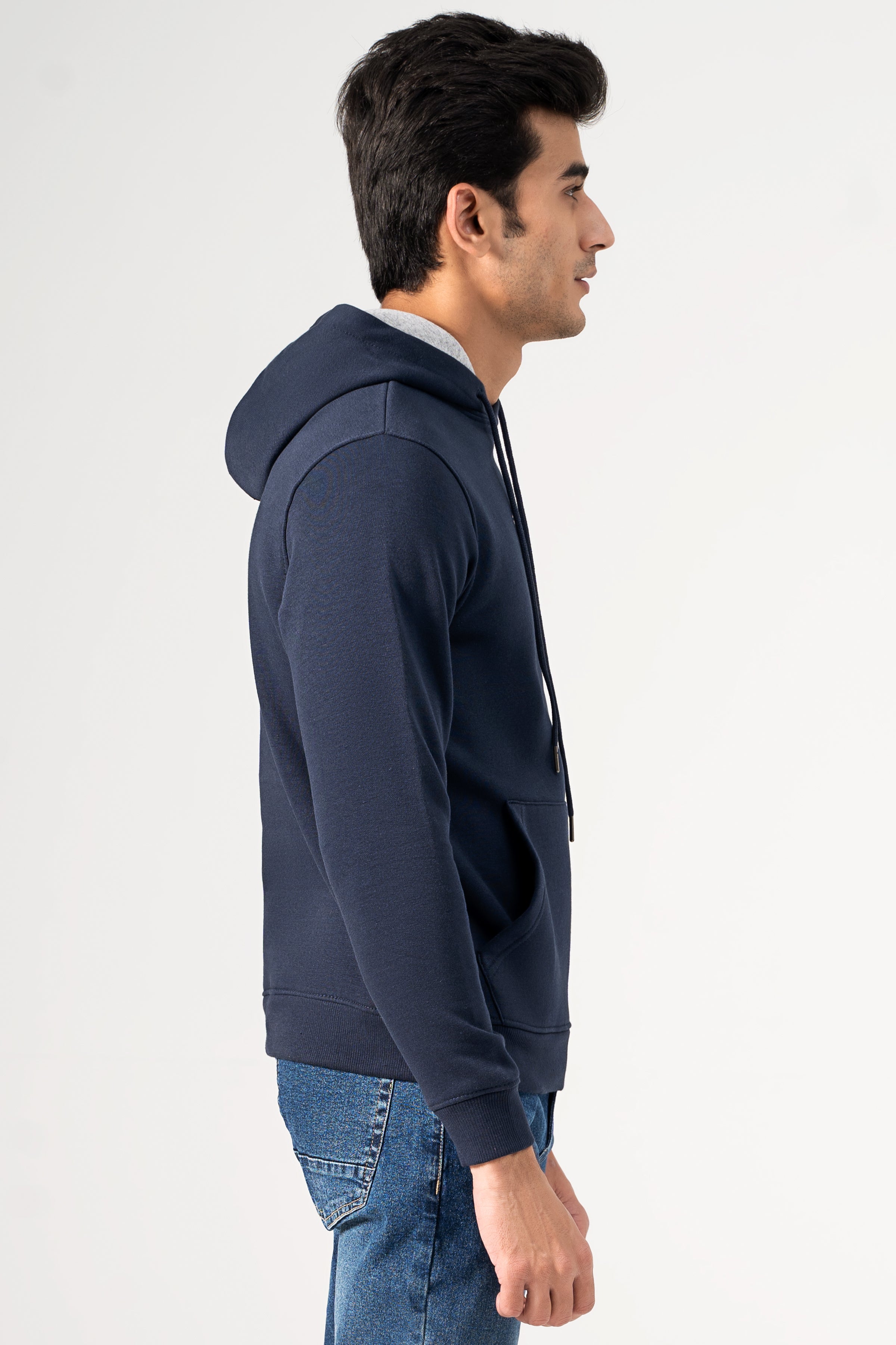 Navy hoodie with long sleeves and kangaroo pocket, side view on model