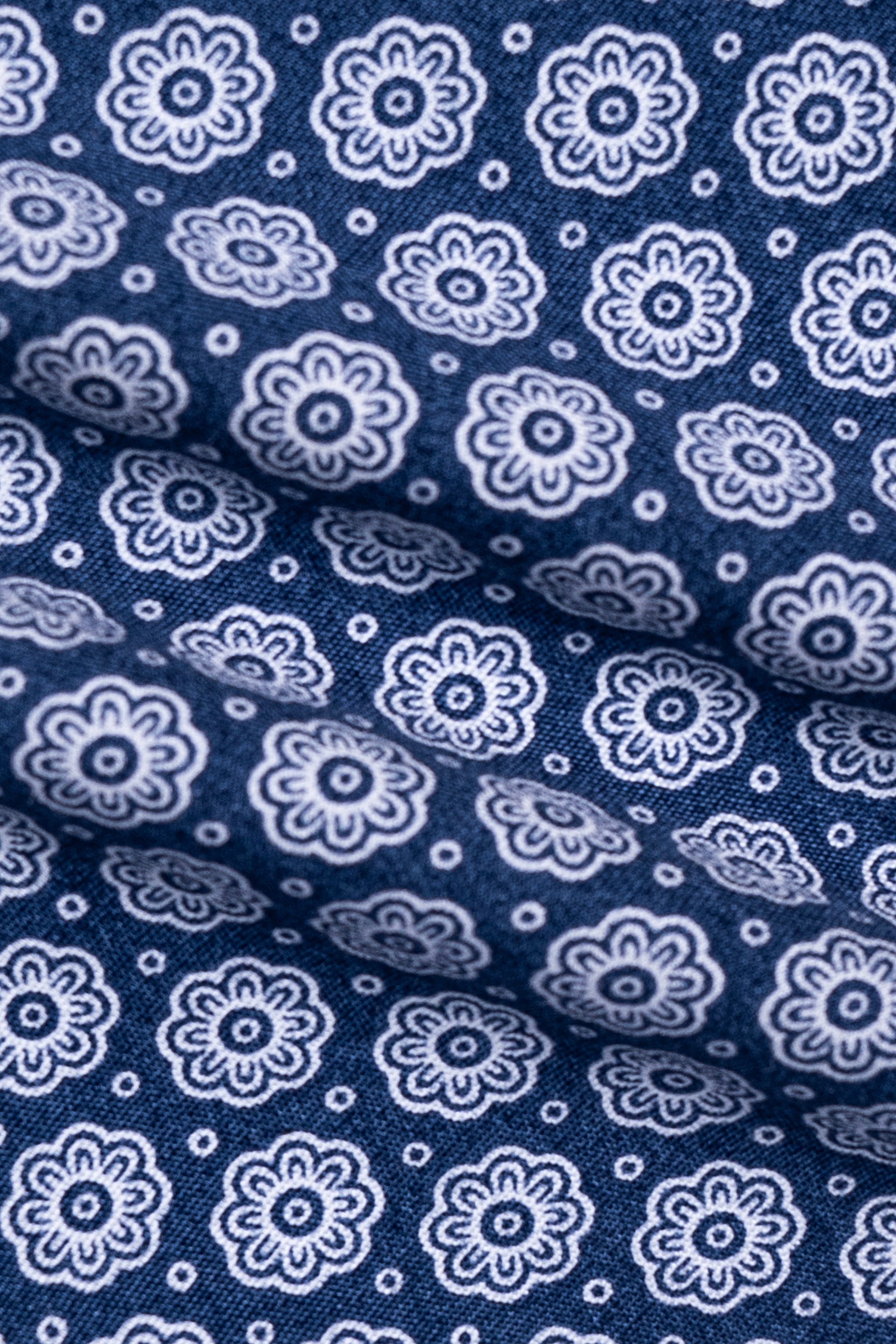 Blue dress shirt fabric with repeating white flower medallion pattern