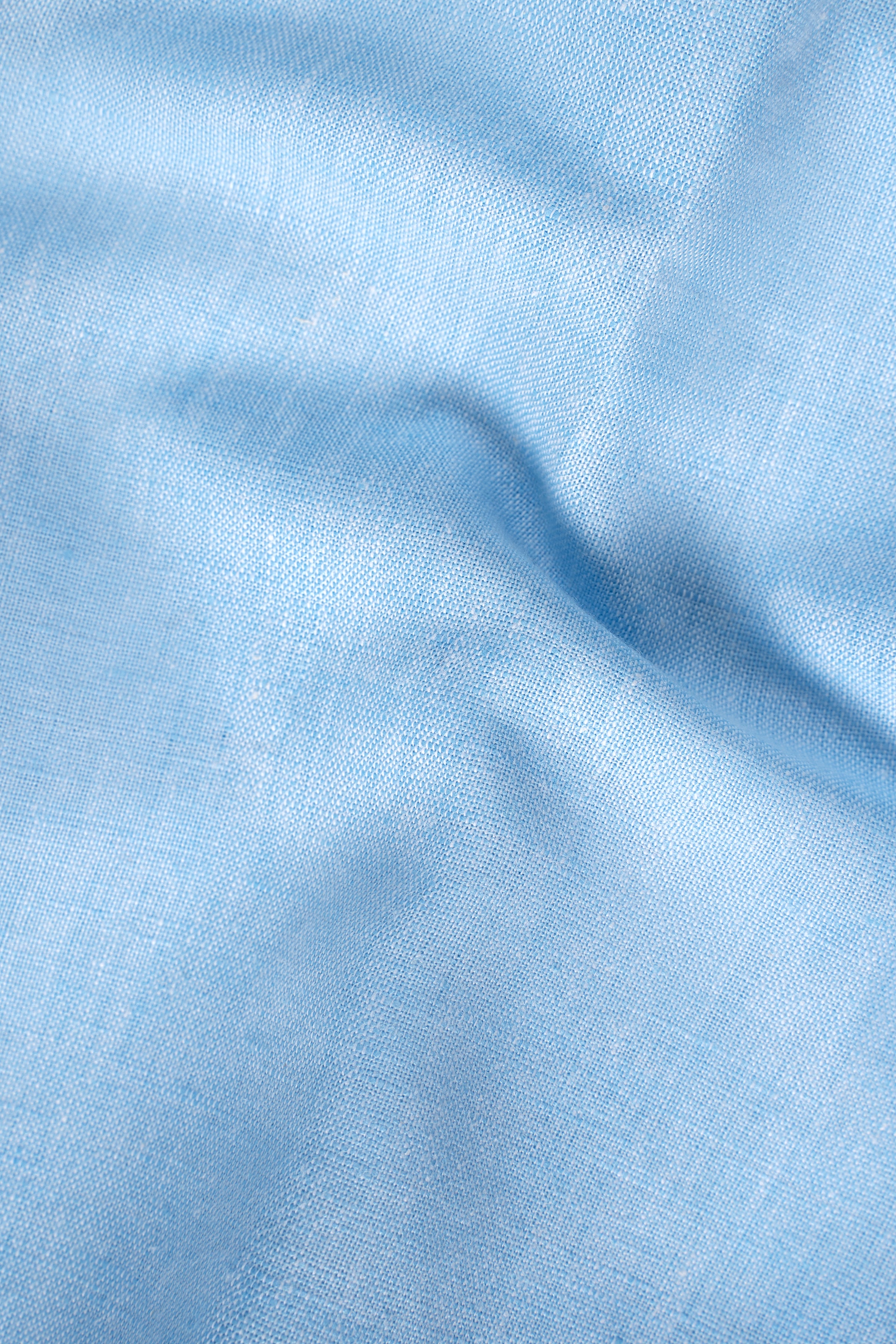 Linen fabric shirt in light sky blue, textured close-up