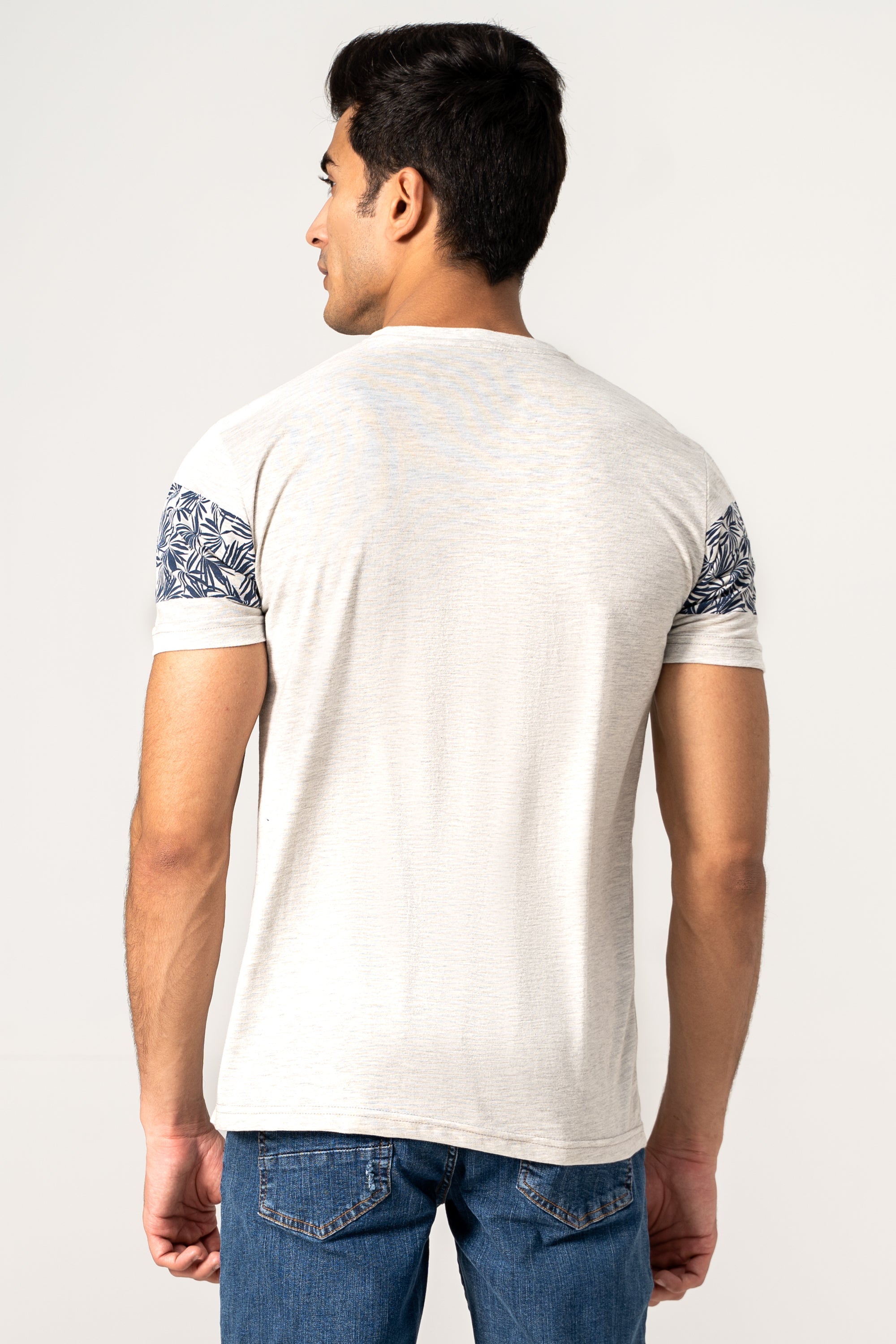 Off-white T-shirt with blue patterned band on upper back and sleeves