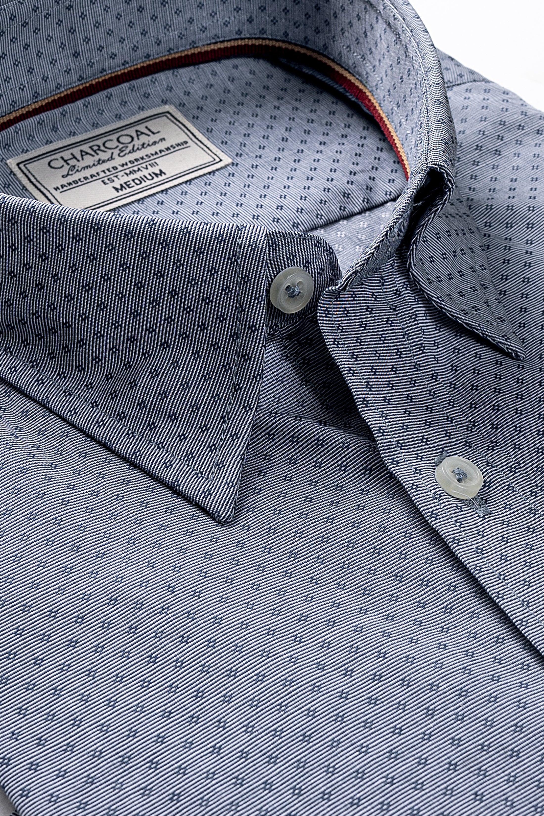 Greenish-blue patterned dress shirt collar and button placket detail
