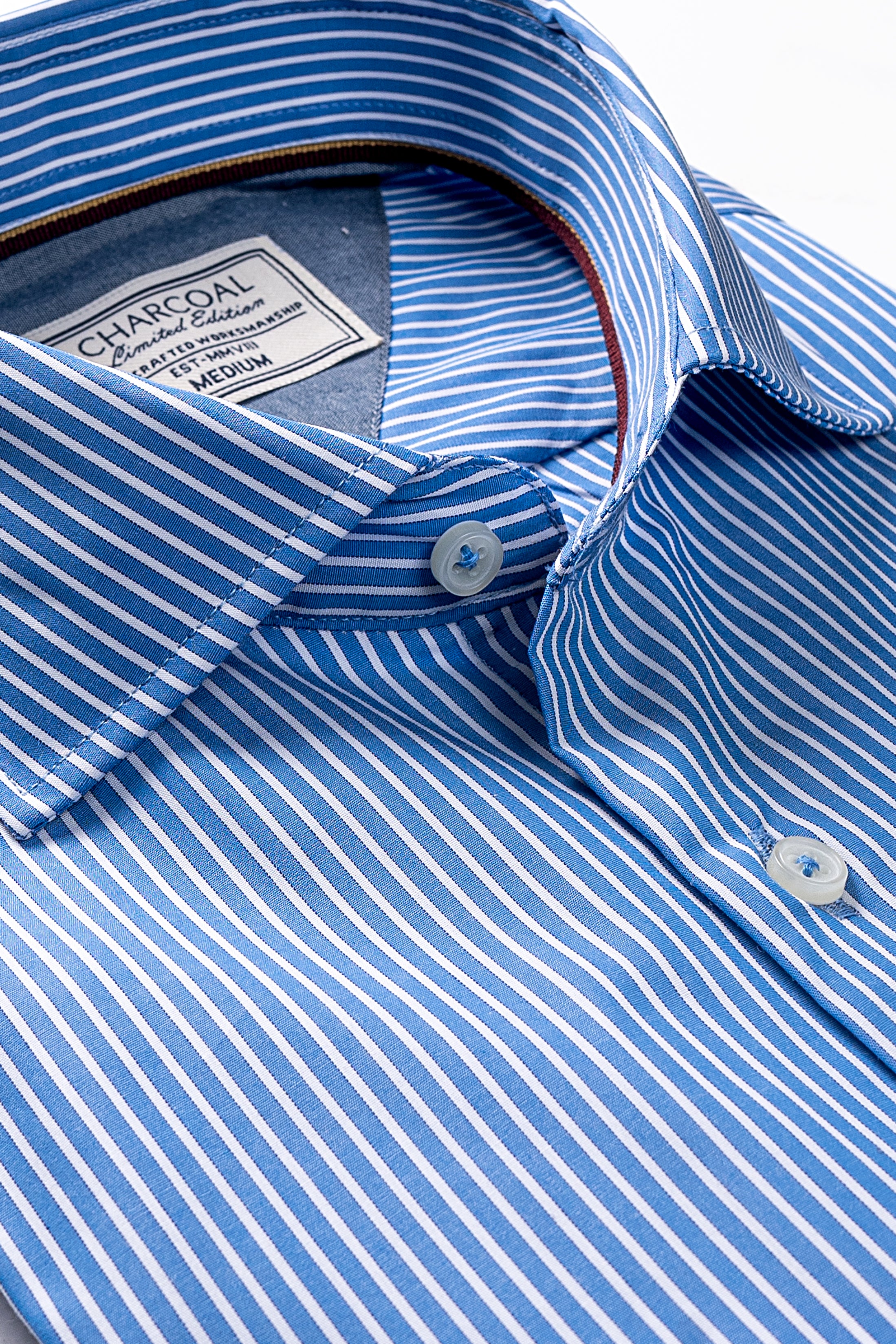 Blue-and-white striped dress shirt collar and button placket detail