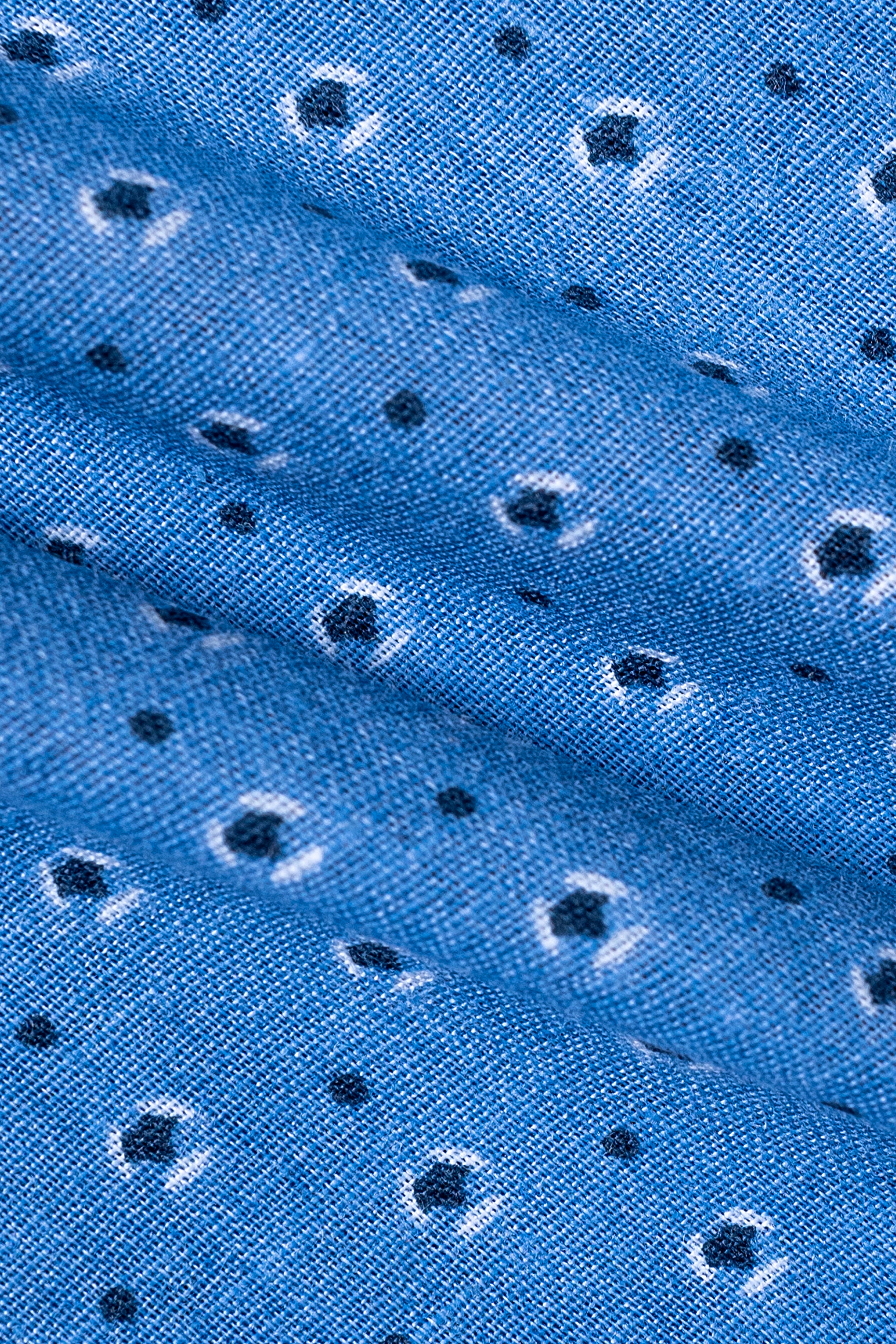Sky blue dress shirt fabric with small dotted pattern, close-up