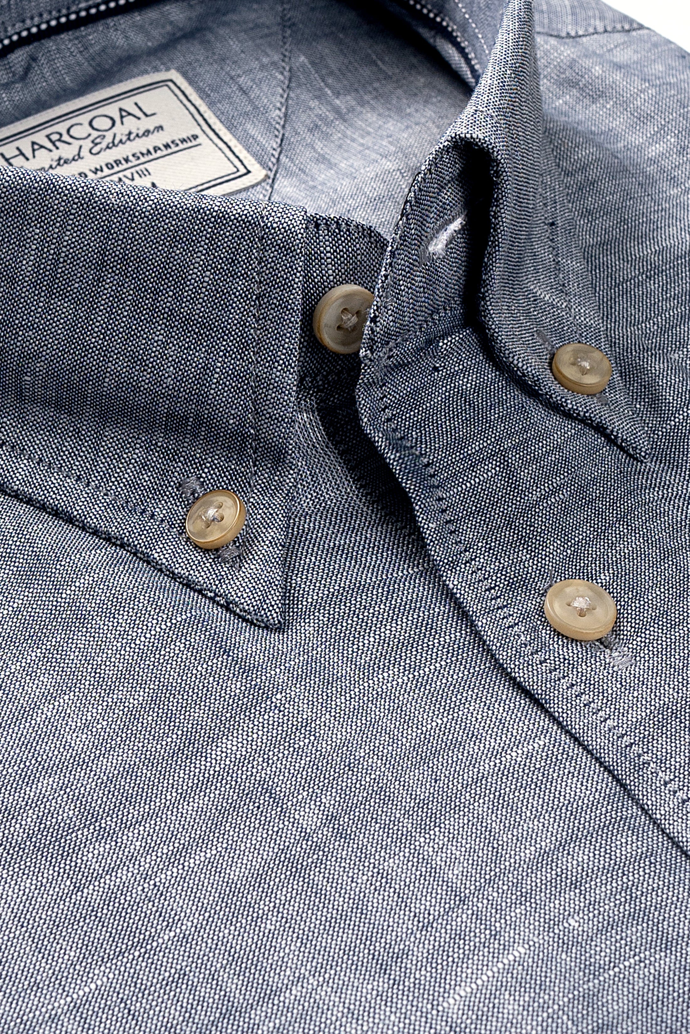 Bluish grey linen shirt close-up: placket with round buttons and pointed collar