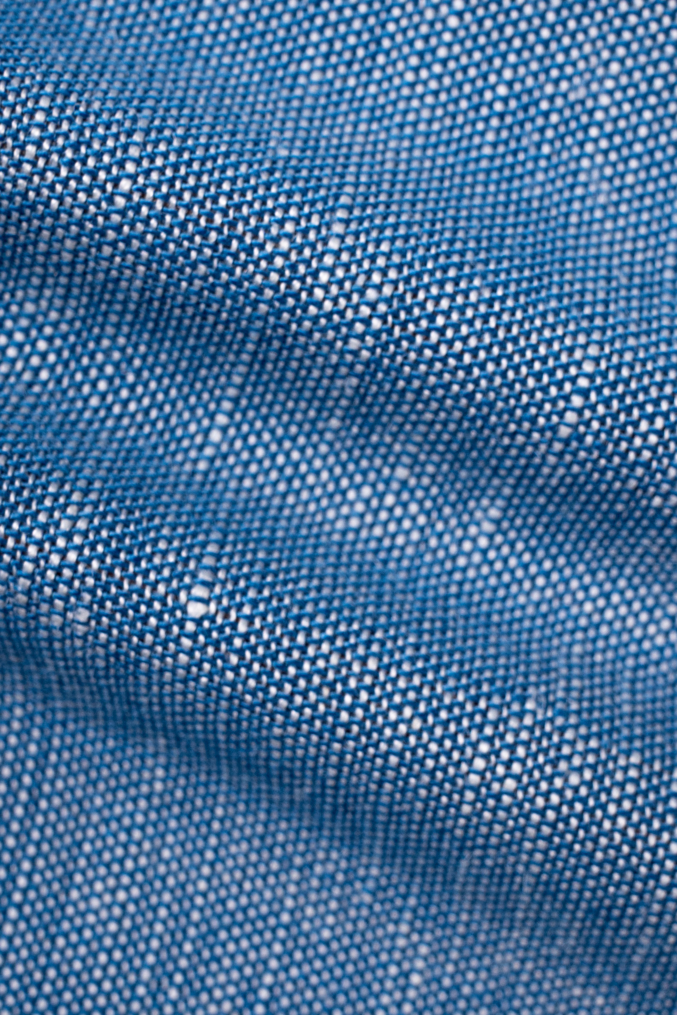 Blue chambray linen fabric close-up showing woven texture