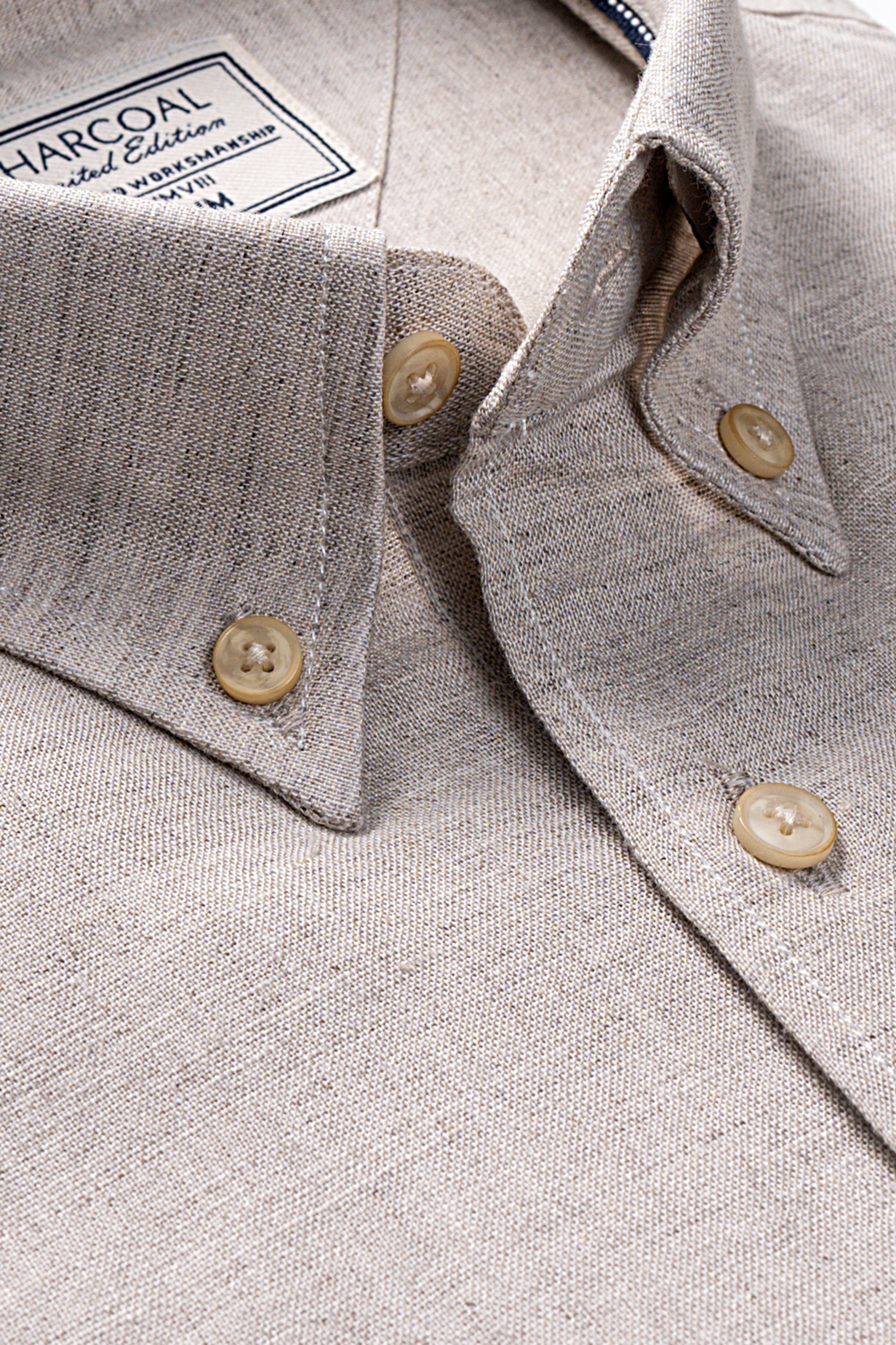 Light khaki linen shirt collar with gold buttons and stitched placket