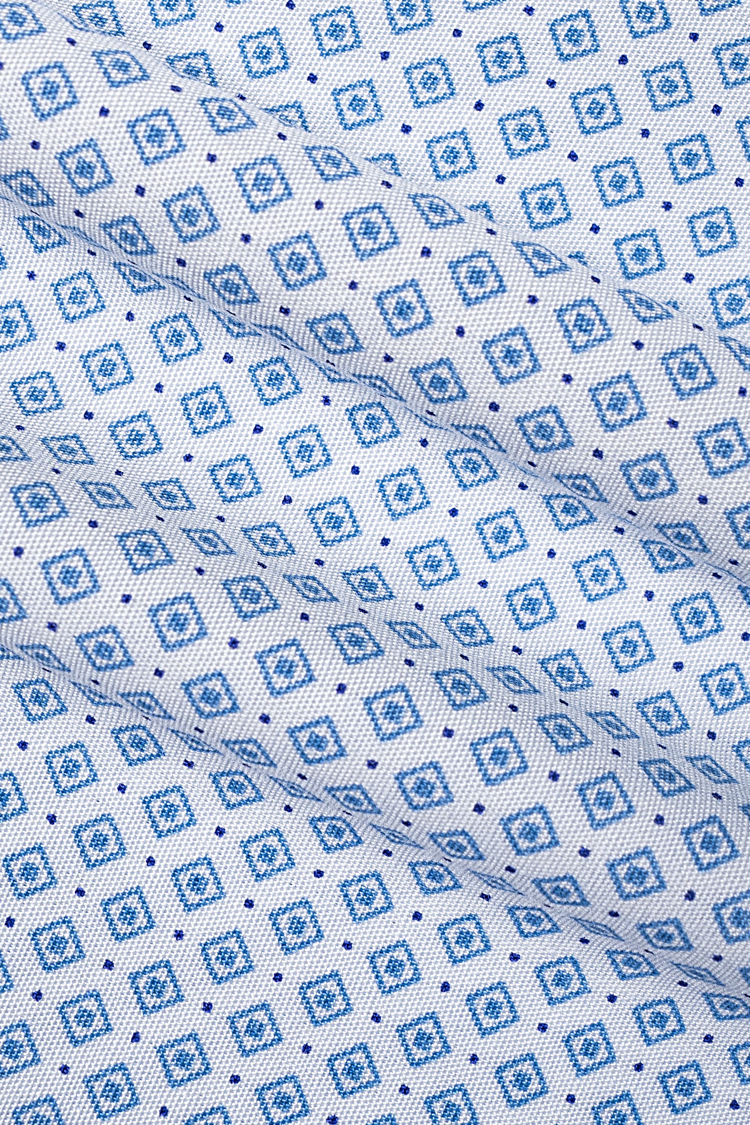 Close-up of light blue printed fabric with small geometric square pattern