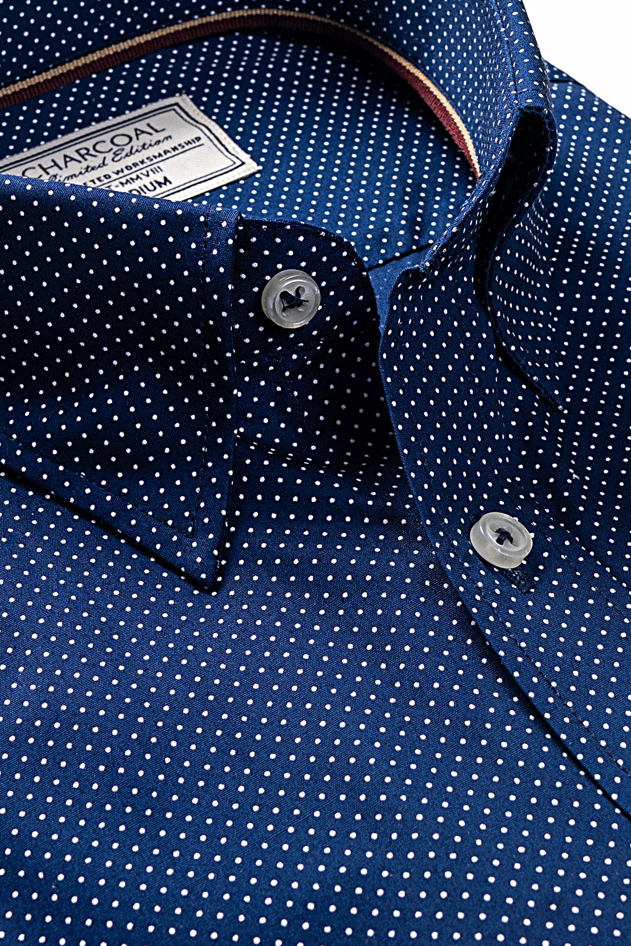 Navy dress shirt collar and placket with white dot pattern, round buttons