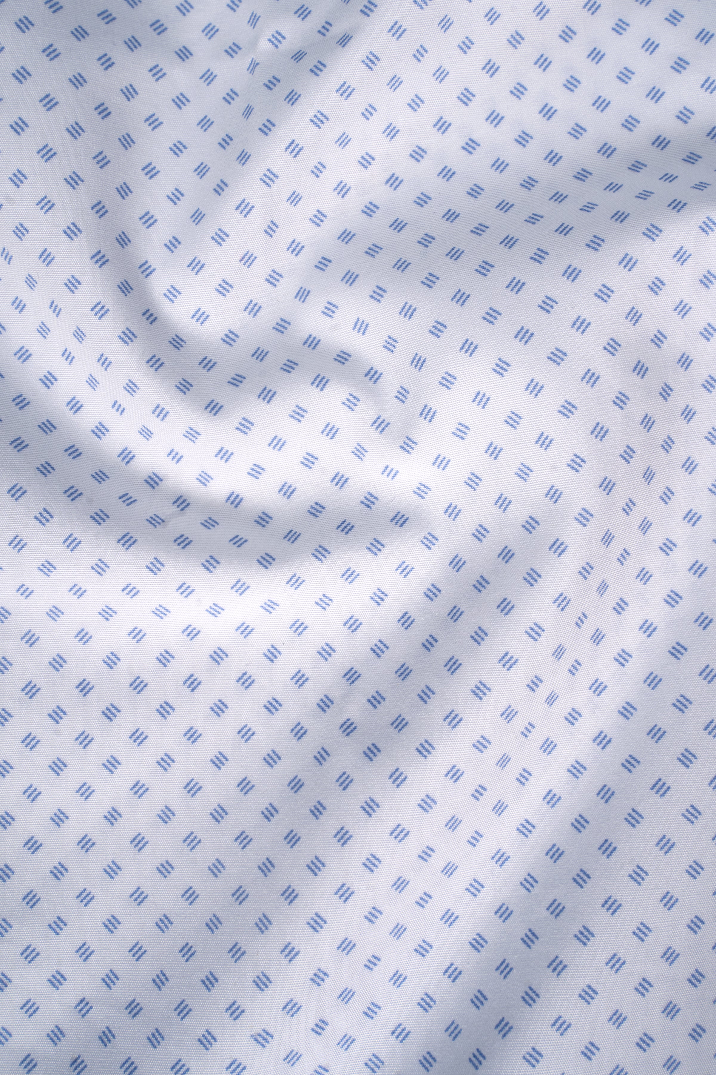 White fabric close-up with small blue square pattern