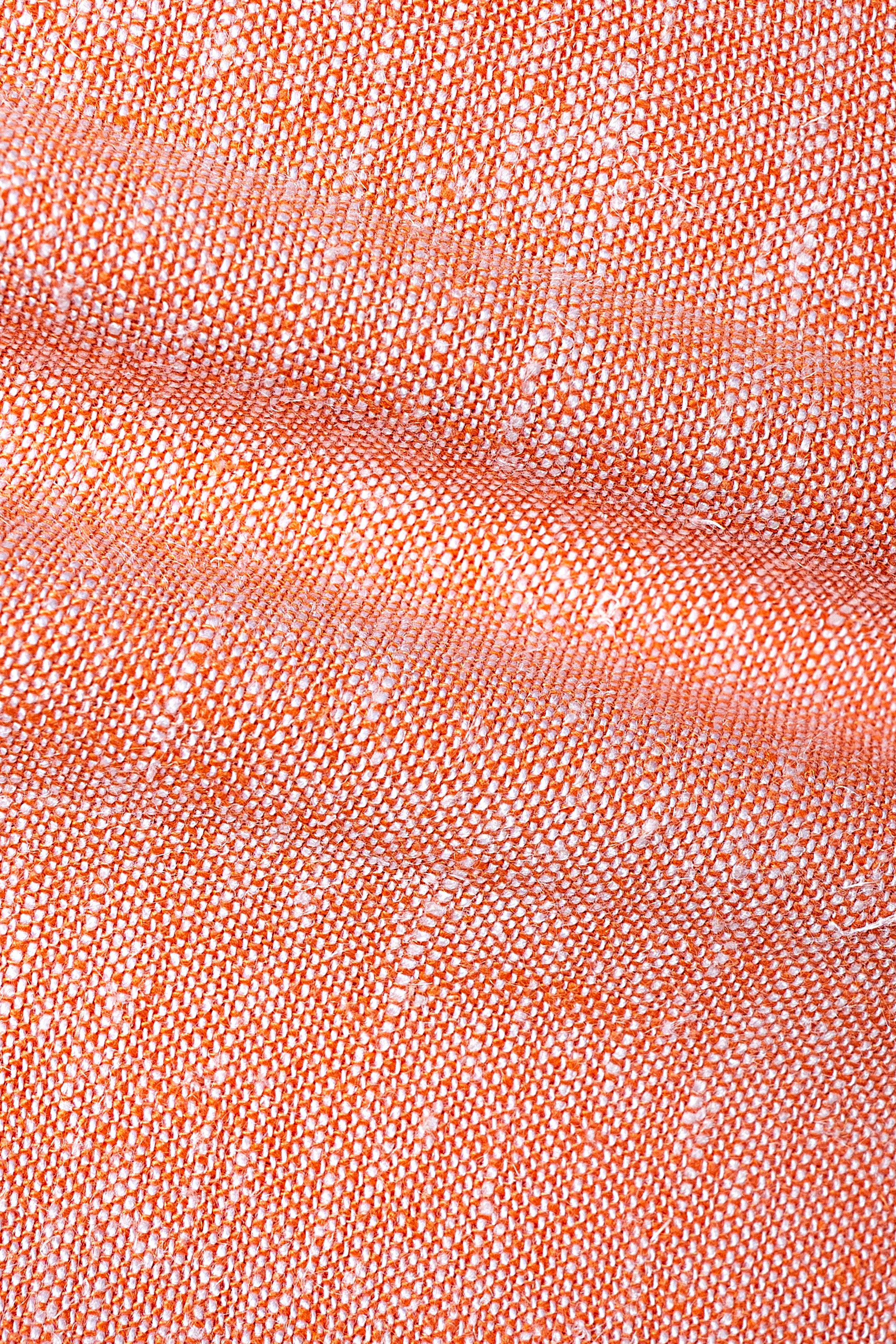 Peach linen fabric texture swatch with fine woven pattern