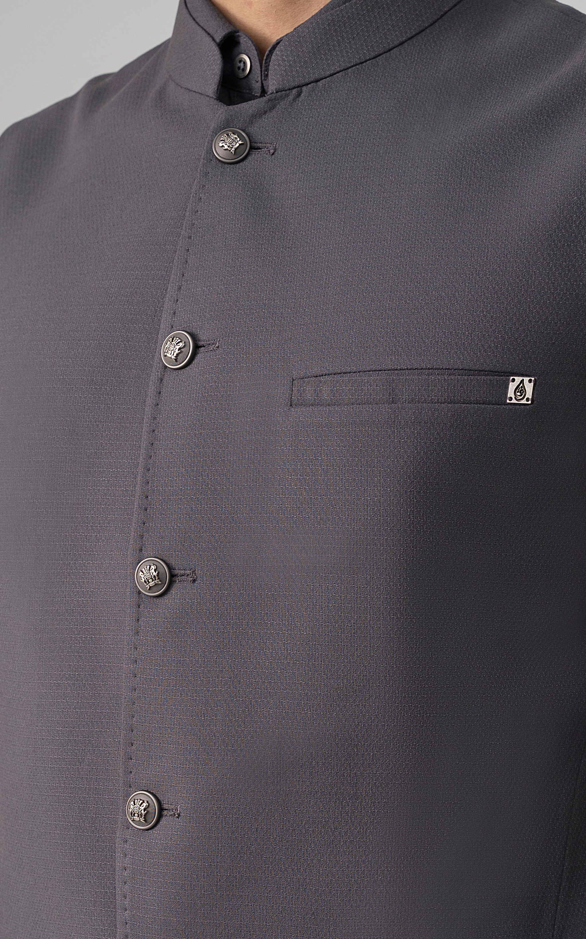 Mid-grey textured waistcoat detail with stand collar, buttons, and pocket