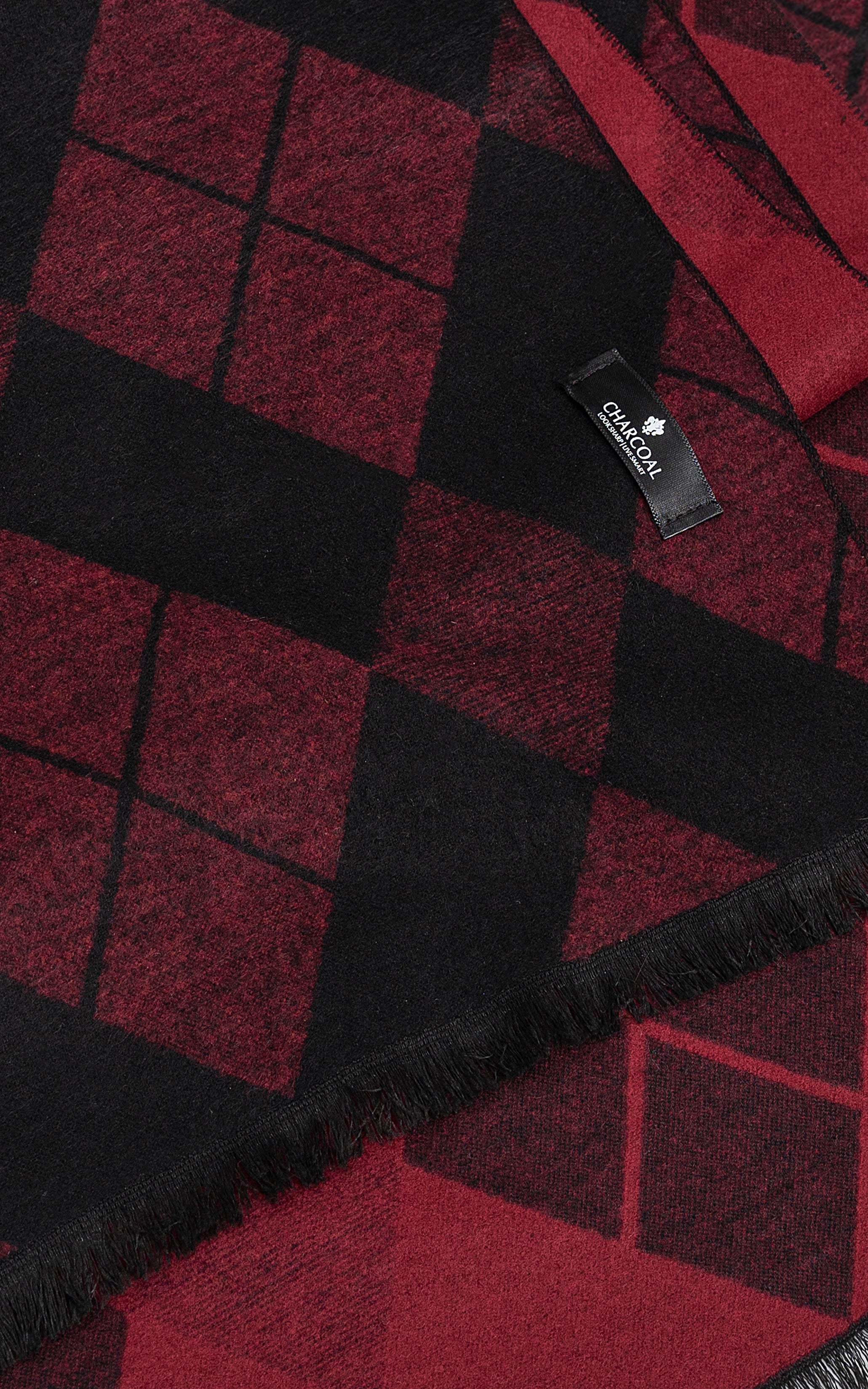 Scarf fabric close-up with diamond check pattern, stitched label and fringe edge