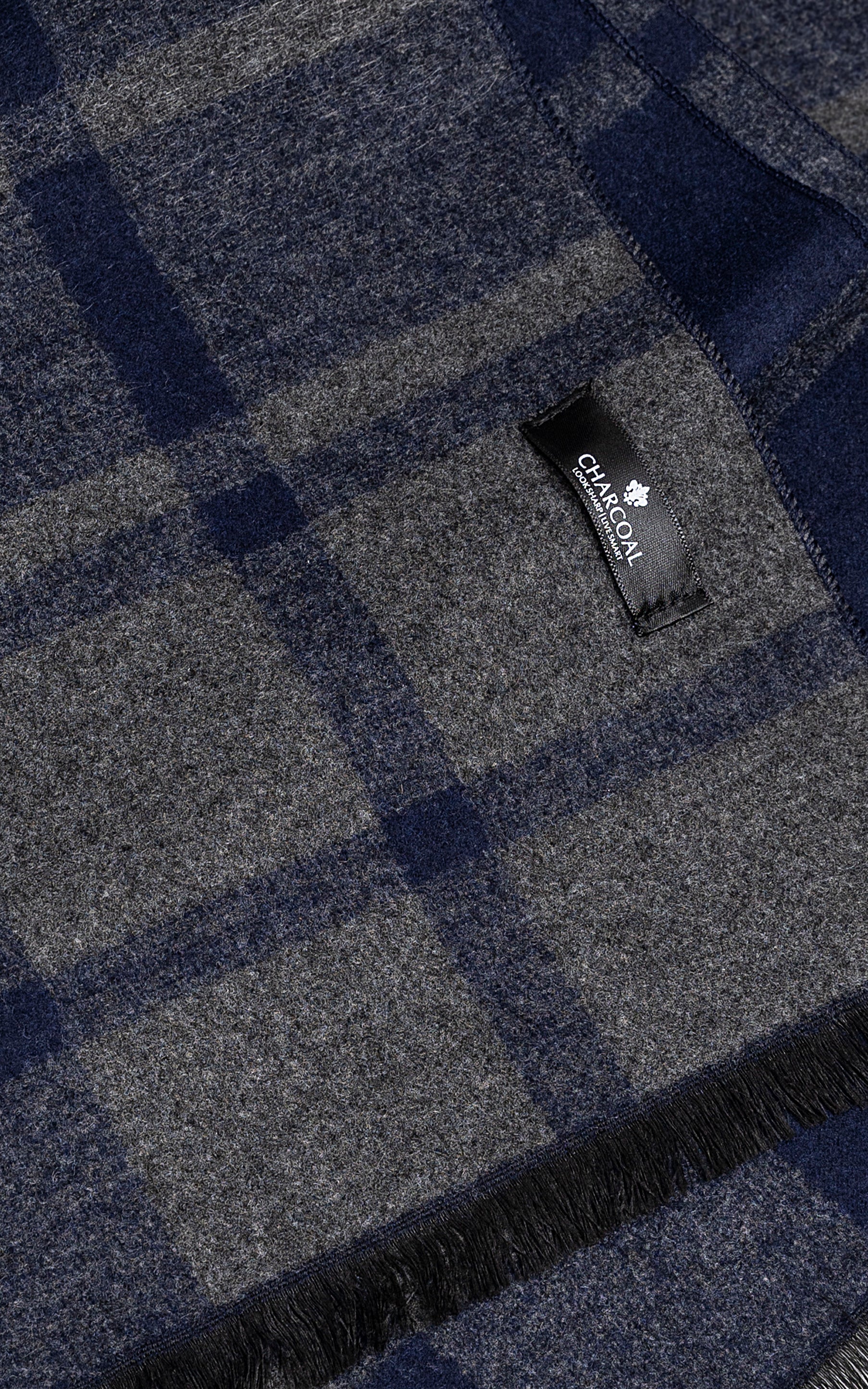Plaid scarf fabric with brand label tag and dark blue-gray pattern