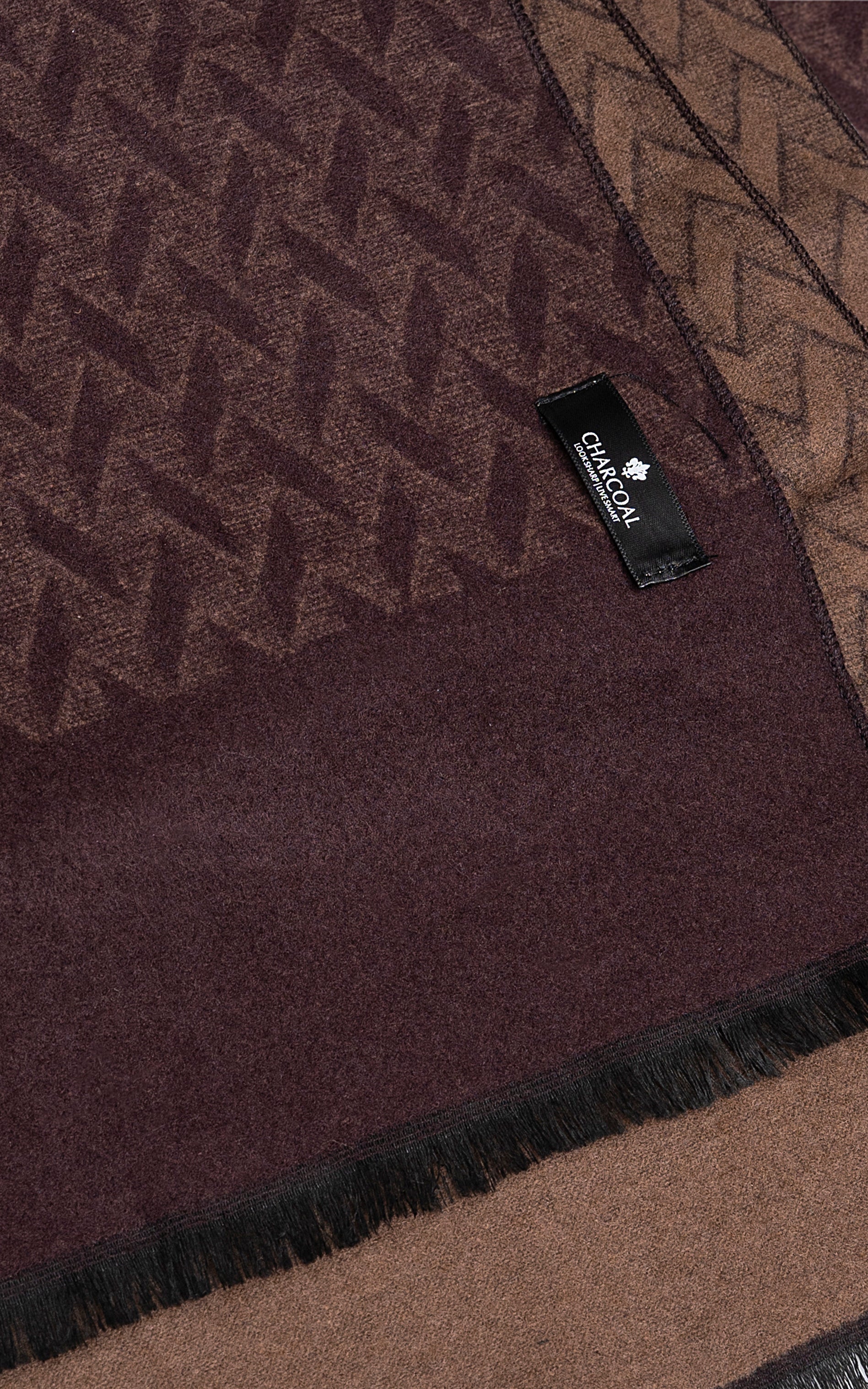 Burgundy scarf close-up with geometric texture and brand label