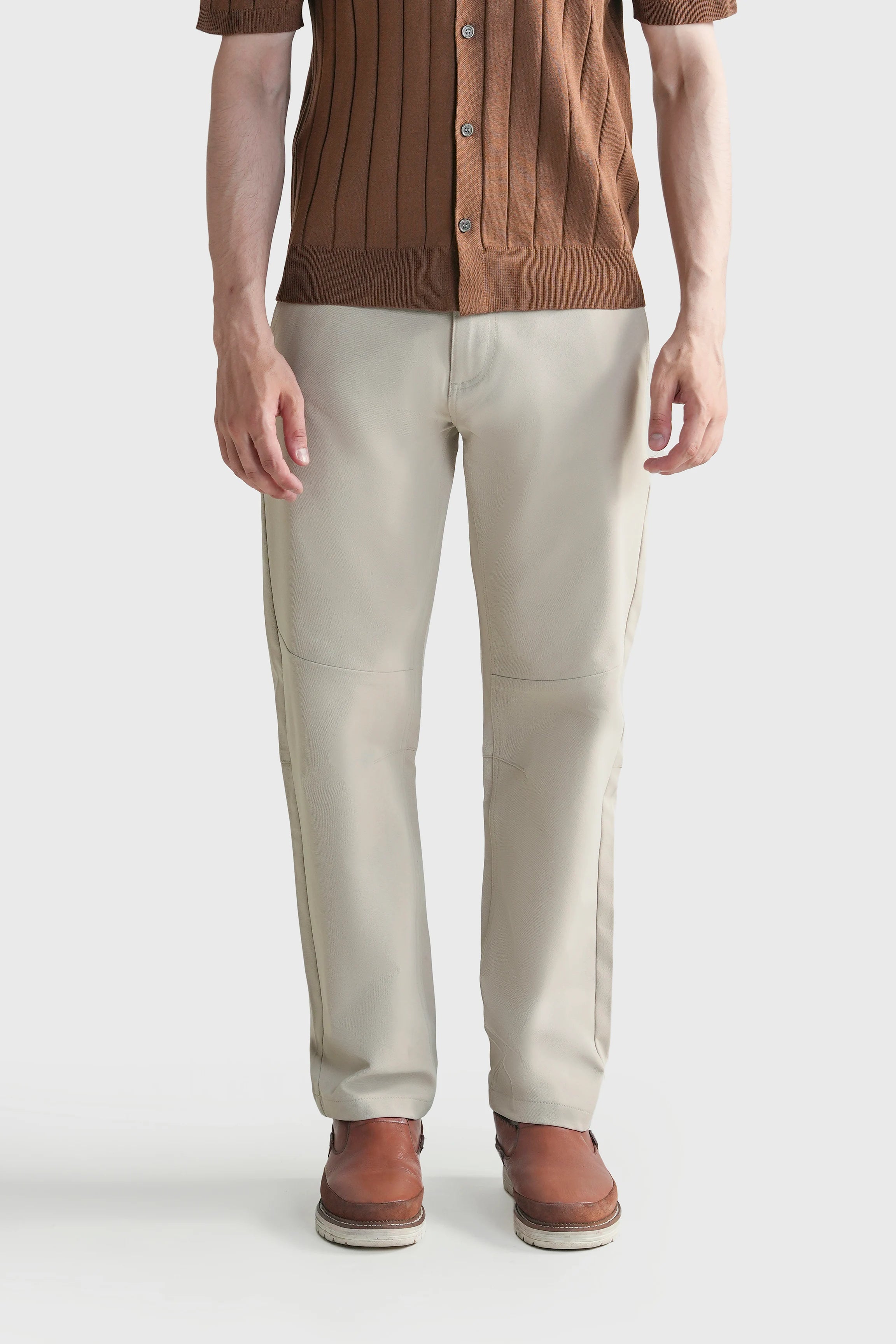 Light beige straight-fit travel pants with belt loops and button-zip front