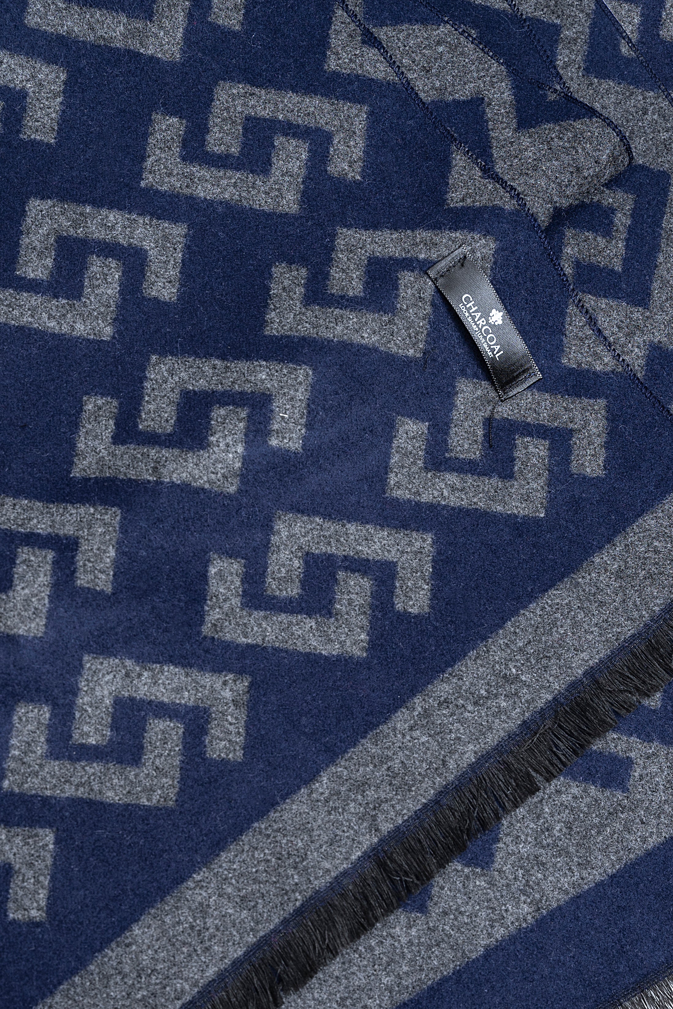 Blue geometric pattern scarf with fringed edge