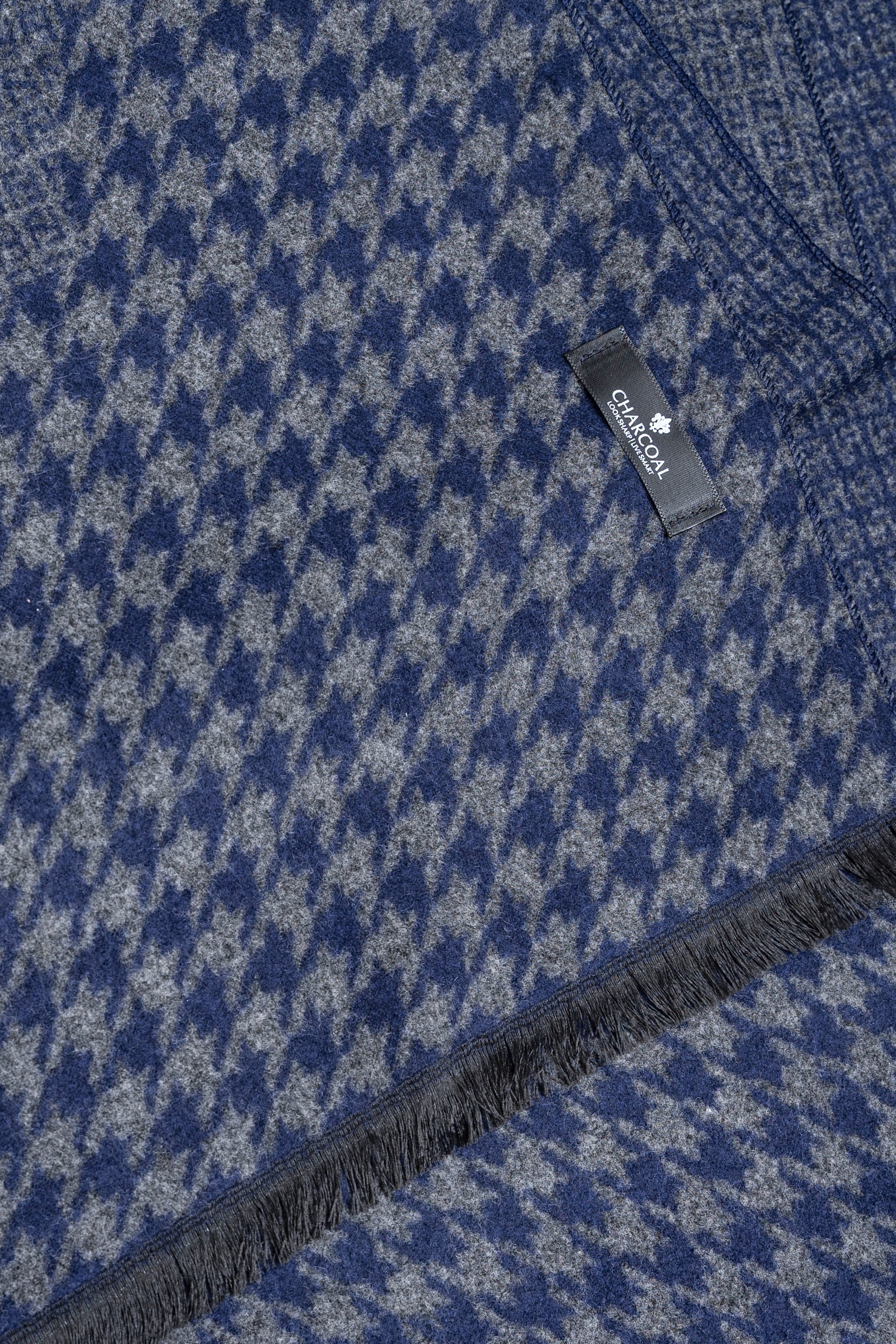 Blue houndstooth scarf with dark fringe and brand label