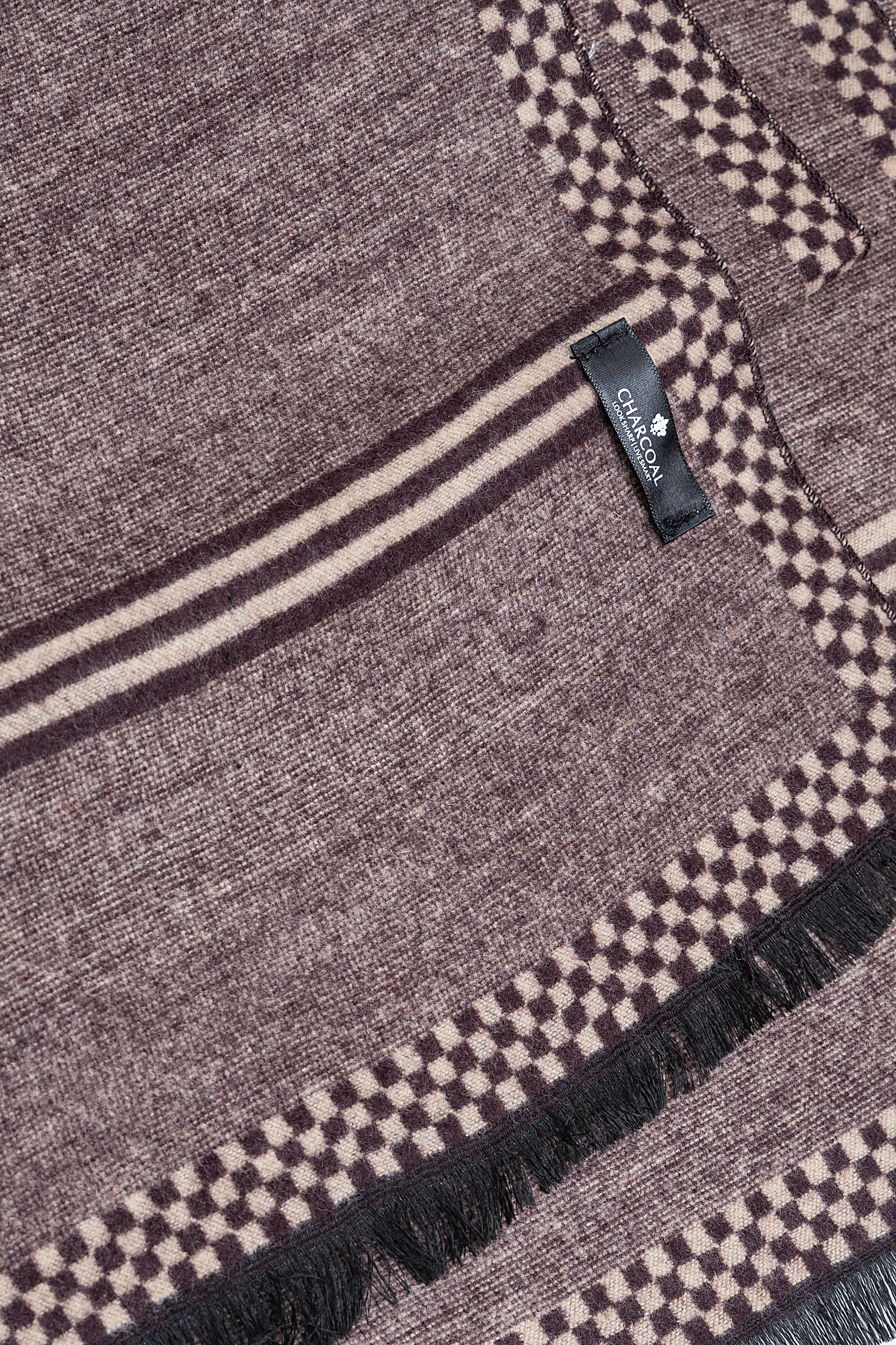 Grey scarf with check border, striped band, fringed edge, and small brand label.